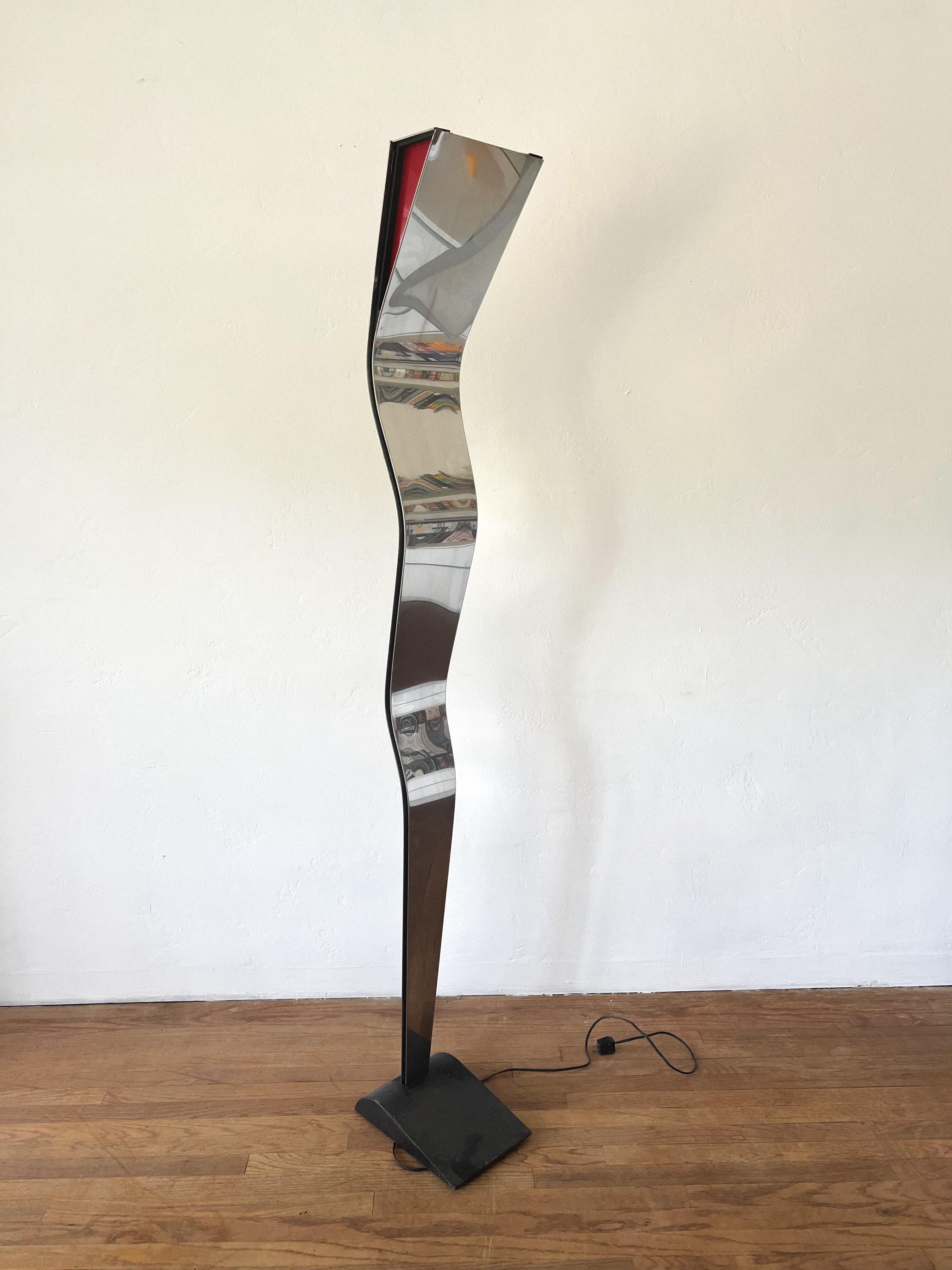 This is a very rare postmodern piece that has been attributed to Italian firm Fontana Arte circa 1970s.

Lamp features a chrome sculptural frame with a very heavy base for stability. On the top it comes with a red film that acts as a lamp shade but