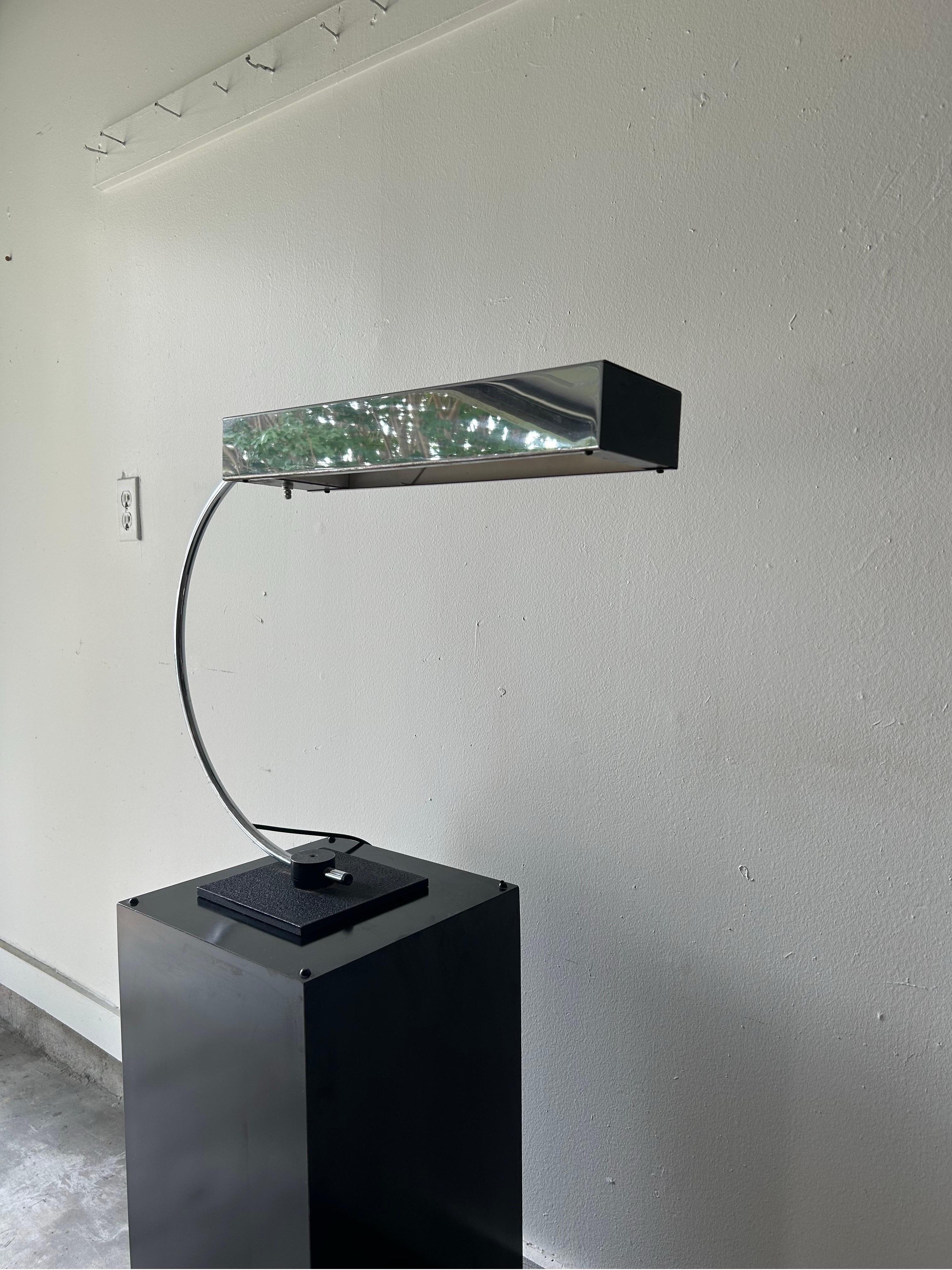 Large chrome, postmodern table lamp with a black square base, curved, stem, and large rectangular shade