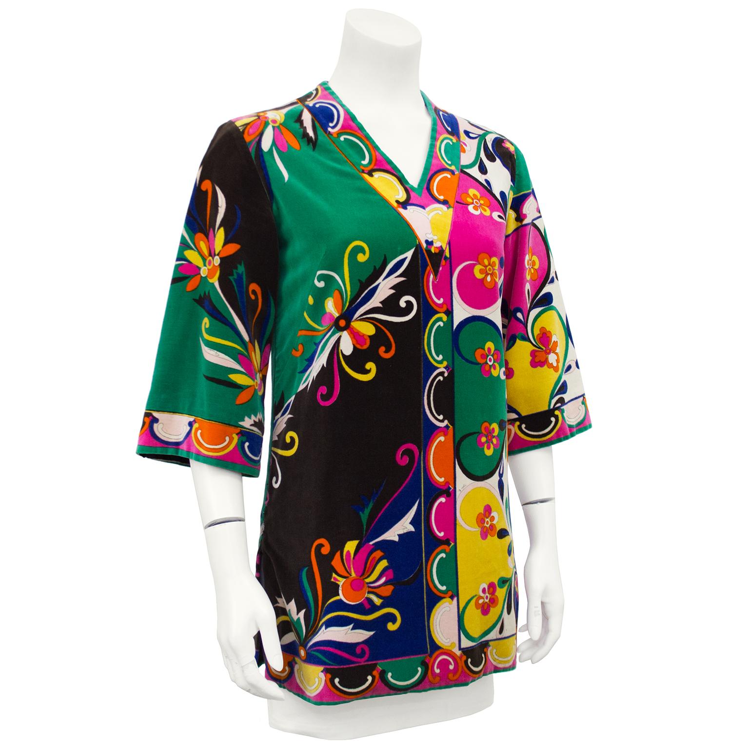 Gorgeously printed Emilio Pucci velvet tunic from the 1970's. The brightly printed top has a V neck, wide elbow length sleeves and a zipper on the side for easy wearing. The bold print is light on one side and dark on the other with a beautiful