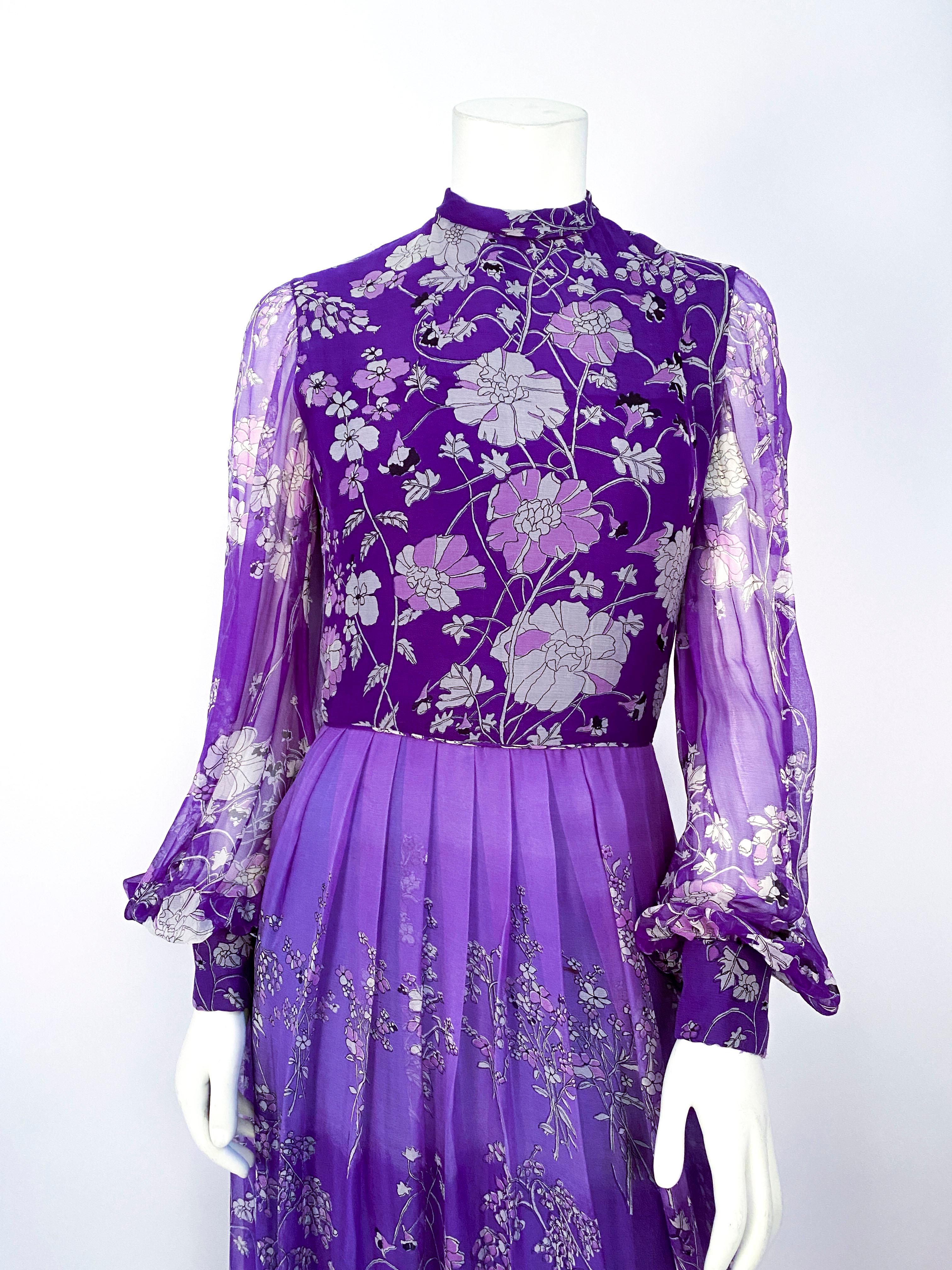1970s purple psychedelic floral printed dress made of a fine silk chiffon. The full length skirt is custom died with a lavender to violet ombre effect --the rayon lining is two-toned to enhance the ombre coloring. The bishop sleeves are transparent
