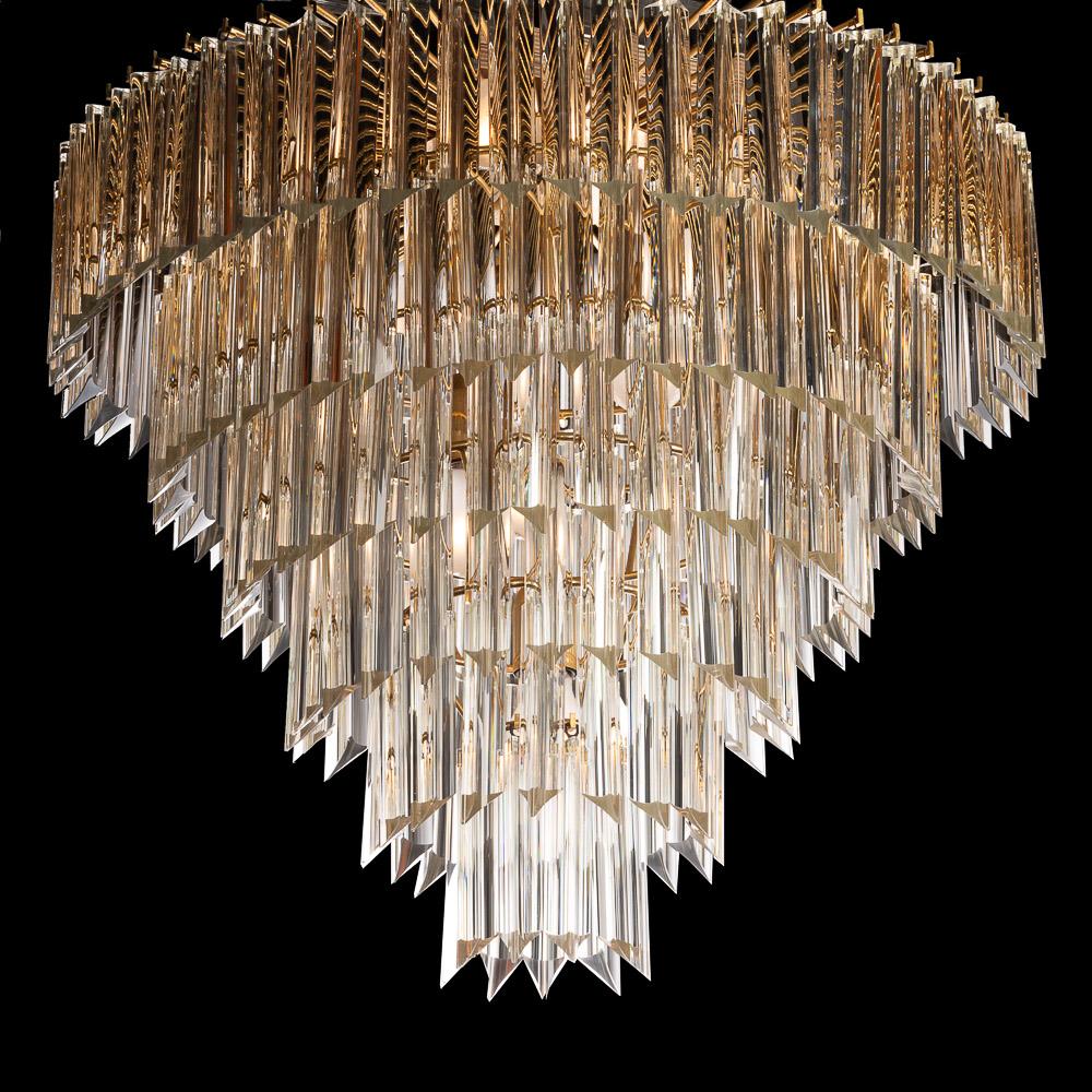 Looking for lighting that makes an impression? This is the one! Hanging from a brass frame, a spectacular arrangement of Quadriedri Murano glass bars. We have two in stock, This one has a sharp glass tip pointing downwards. This makes this light