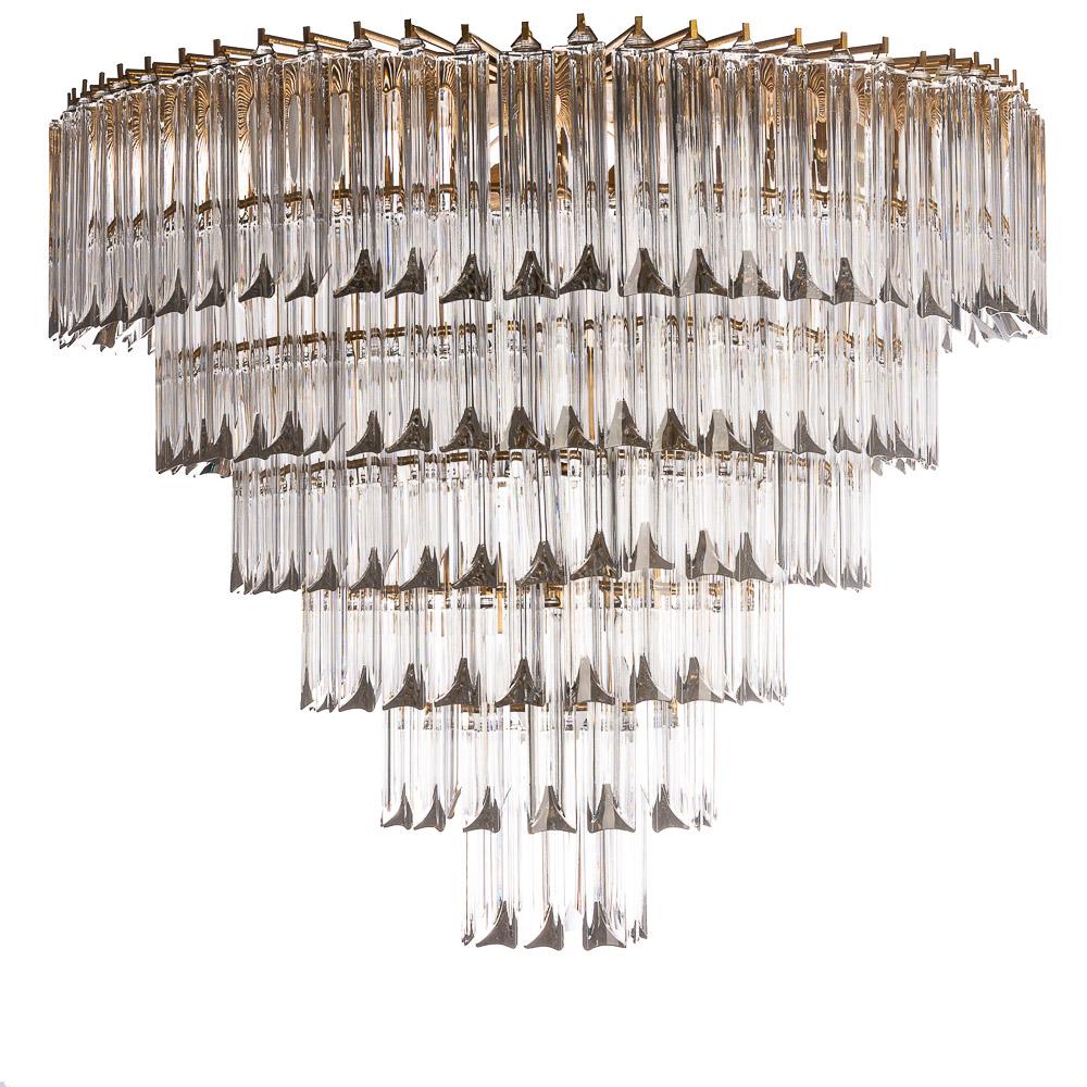 Looking for lighting that makes an impression? This is the one! Hanging from a brass frame, a spectacular arrangement of Quadriedri Murano glass bars. We have two in stock, This one has two angels of glass pointing downwards. This makes this light