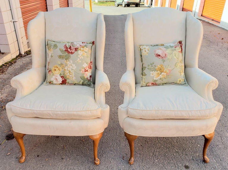 Stunning pair of vintage Queen-Anne style wing-back chairs in a neutral cream Swiss dot fabric. (I believe the maker is Hickory, but the label is not on as they have been reupholstered.). The frames are of generous proportions for comfort, and they