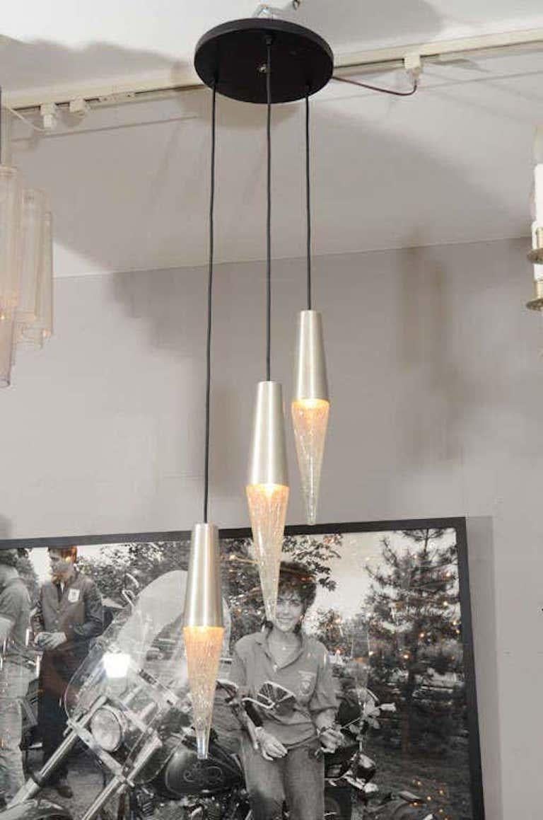 Simple modernist 1970's RAAK three pendant fixture in a cascading manner.