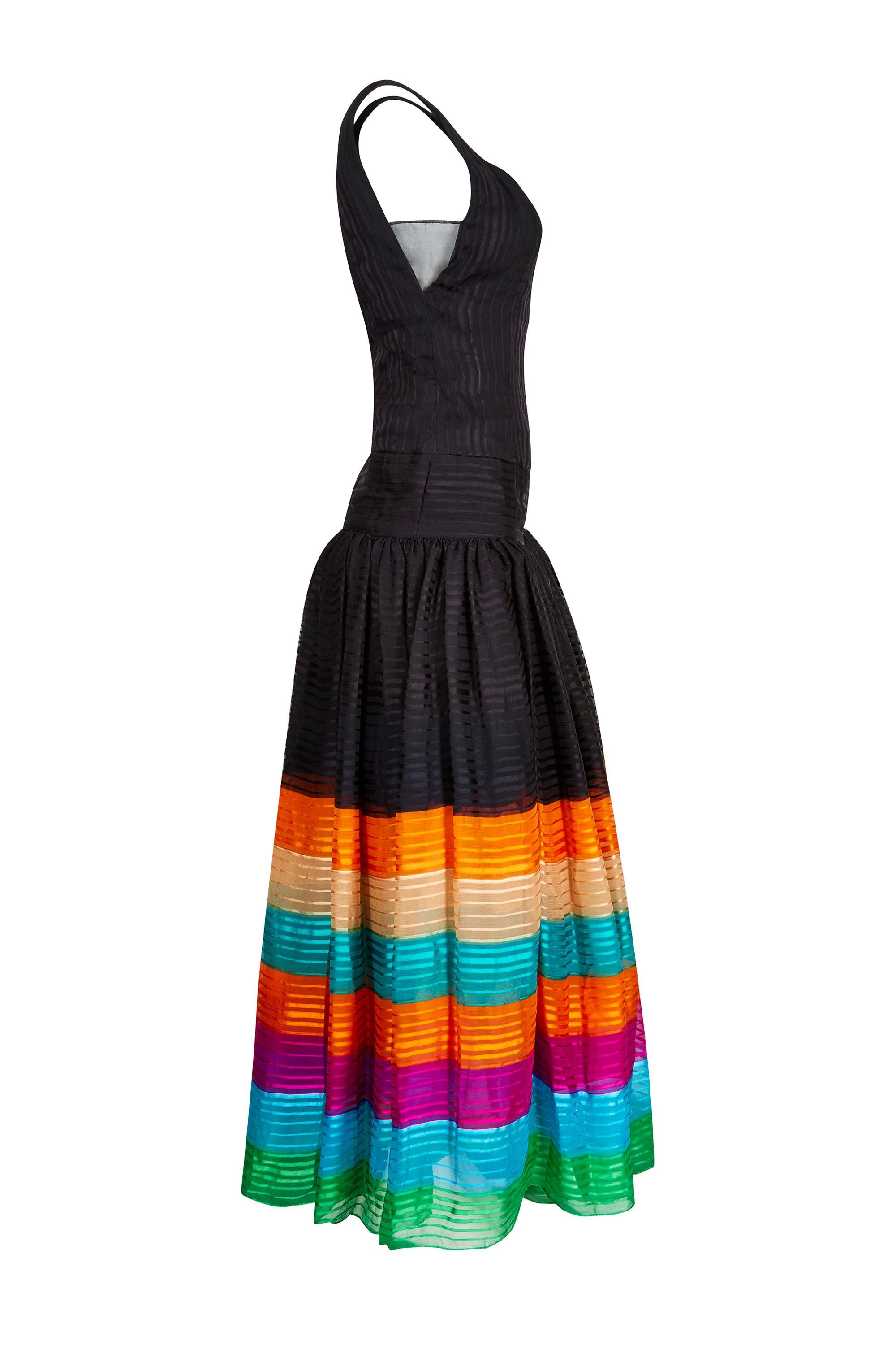 This vivacious 1970s pure silk chiffon haute couture dress with rainbow hemline is of excellent quality and in superb vintage condition. Although unlabelled, we are able to discern that it is American in origin and is likely to be by one of the most