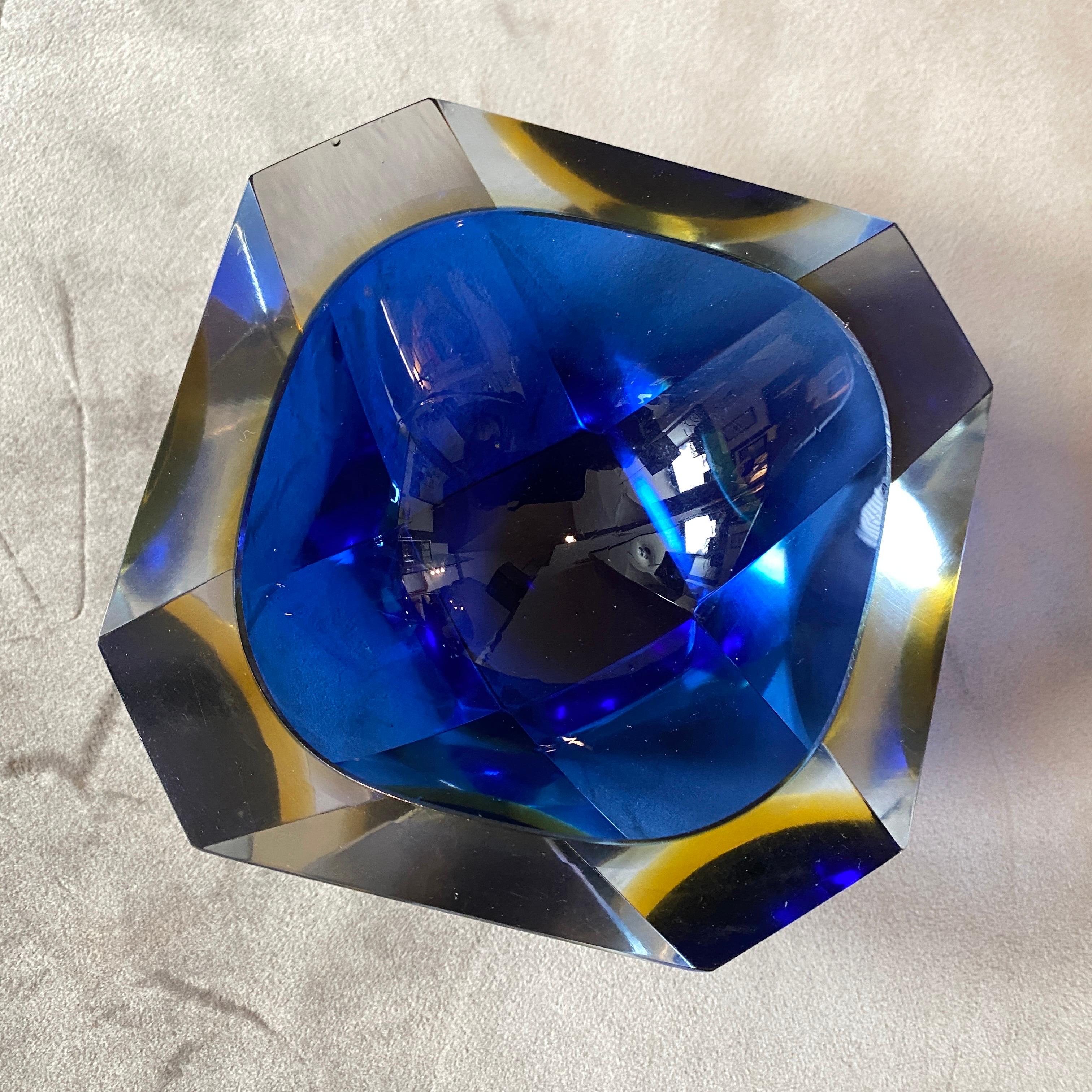 A rare semi faceted murano glass ashtray designed and manufactured by Seguso, it's in perfect conditions. Crafted with precision and artistry, the ashtray boasts a multifaceted surface that catches and reflects light, adding depth and dimension to