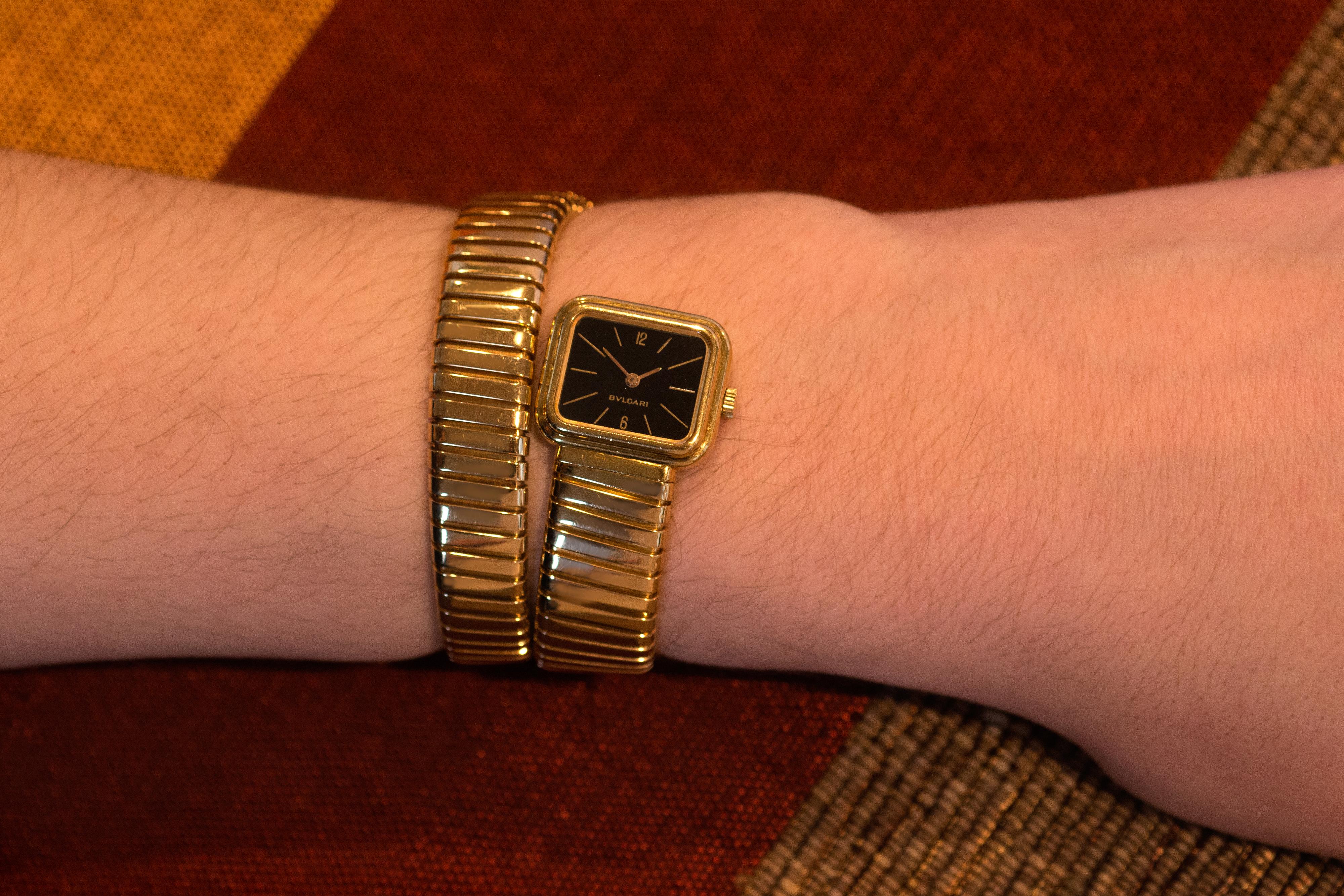 This is an 18 karat gold serpenti tubogas watch with black dial, by Bulgari, 1970s. It has a manual movement and is stamped Bulgari G1113 4, 15777. The bracelet watch is approximately 1.5