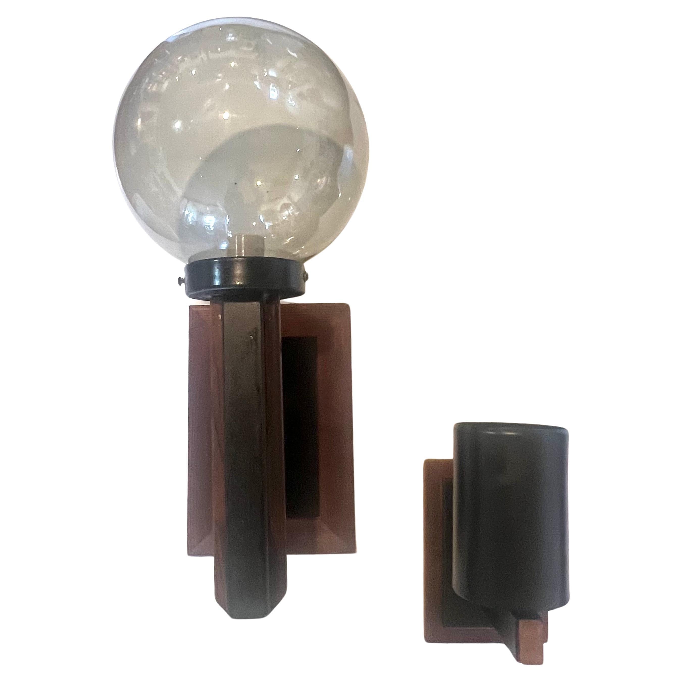 Great pair of outdoor wall sconces in redwood frames with black enameled metal finish, one comes with a smoked glass ball shade,the other one is more of a torchiere wall sconce, a very nice original condition we cleaned and oiled wiring its perfect