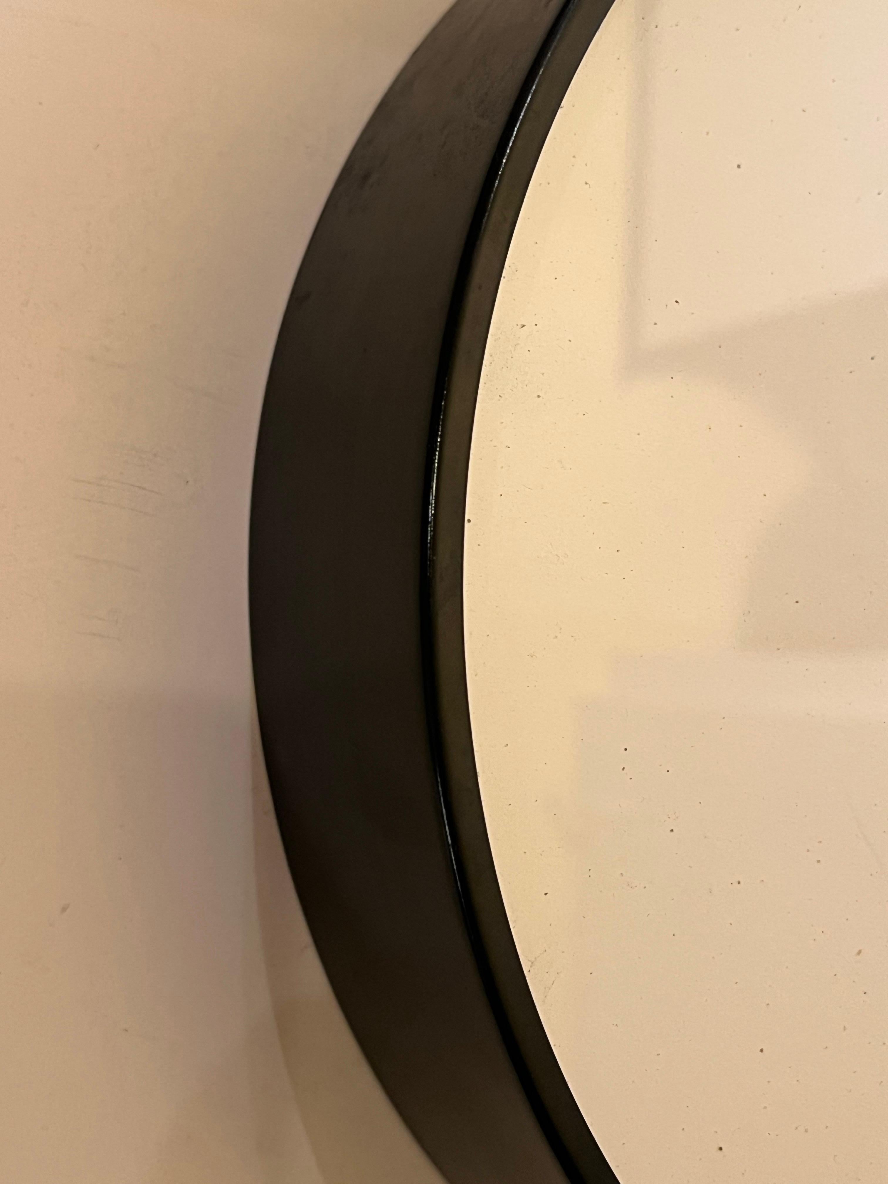 Great design and rare piece circa 1970s glass face with enameled black frame, Classic design by Nathan George Horwitt part of the Museum of Modern Art Collection  Made in The USA, with battery-operated movement. Made by Howard Miller. the clock is