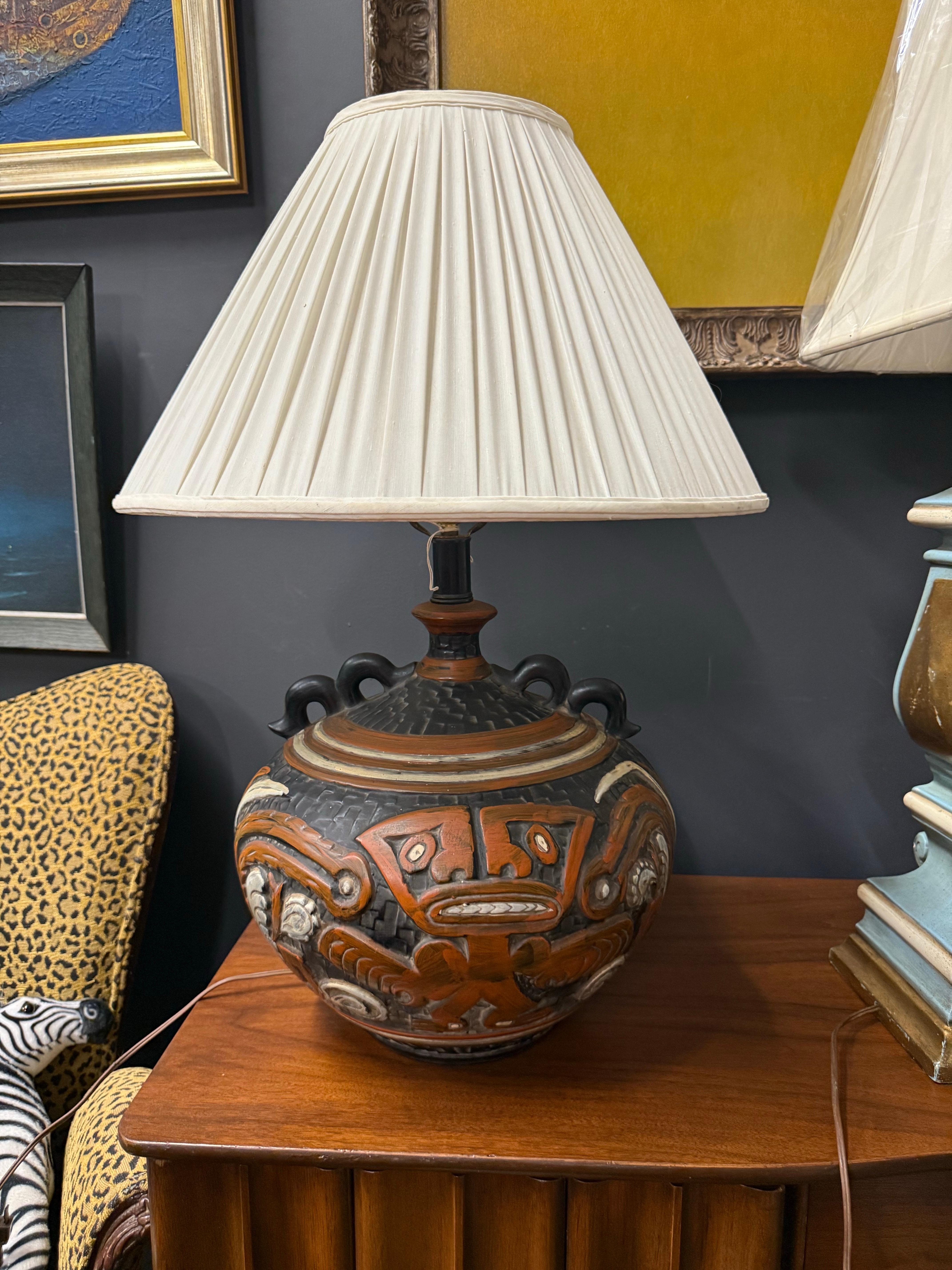 This stunning and funky fresh 1970’s Rare Tiki Mayan Gods Large pottery Table Lamp is in excellent condition with neutral shades of brown and black and cream.  It features double snake handles.  
Lamp shade measures: 13” tall x 20” diameter 
Lamp