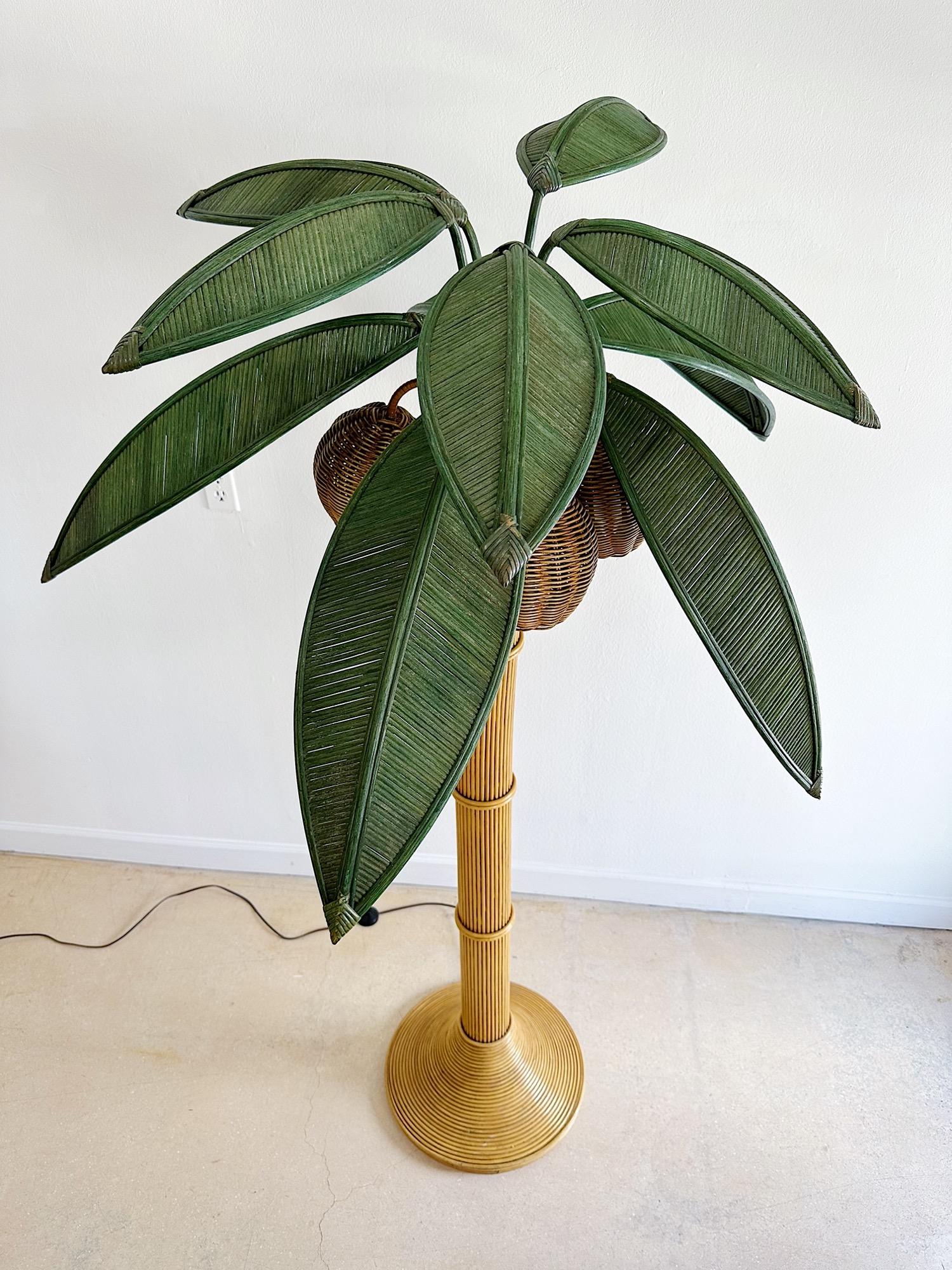 Beachy palm tree floor lamp in amazing vintage condition. Ten wicker leaves and three wicker coconuts with, each with its own light bulb. The leaves remove and twist if you want to set closer to a wall. 


