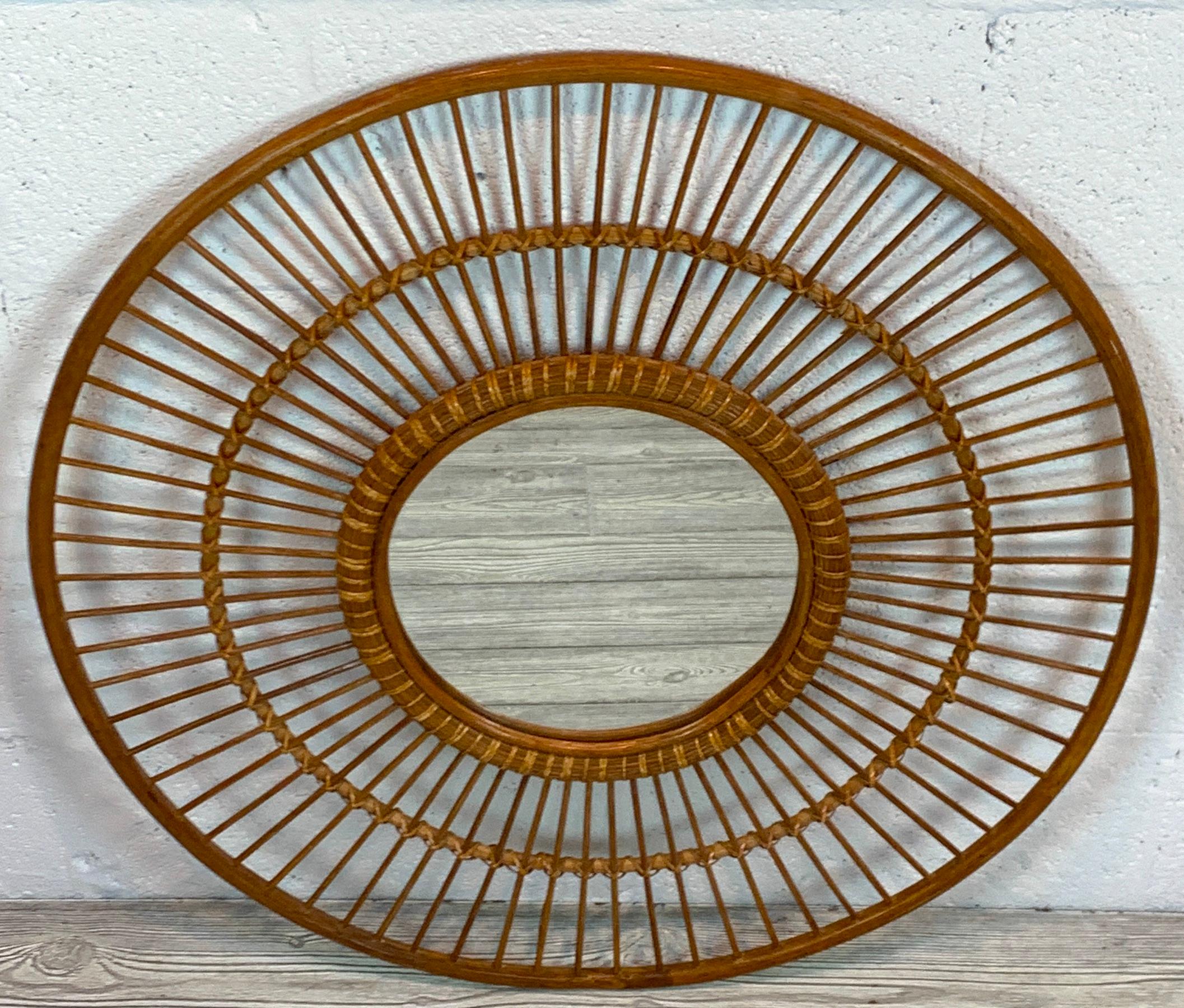 1970s rattan sunburst mirror, finely worked and woven with willow and reed. Complete with an inset 11-inch diameter mirror.
  