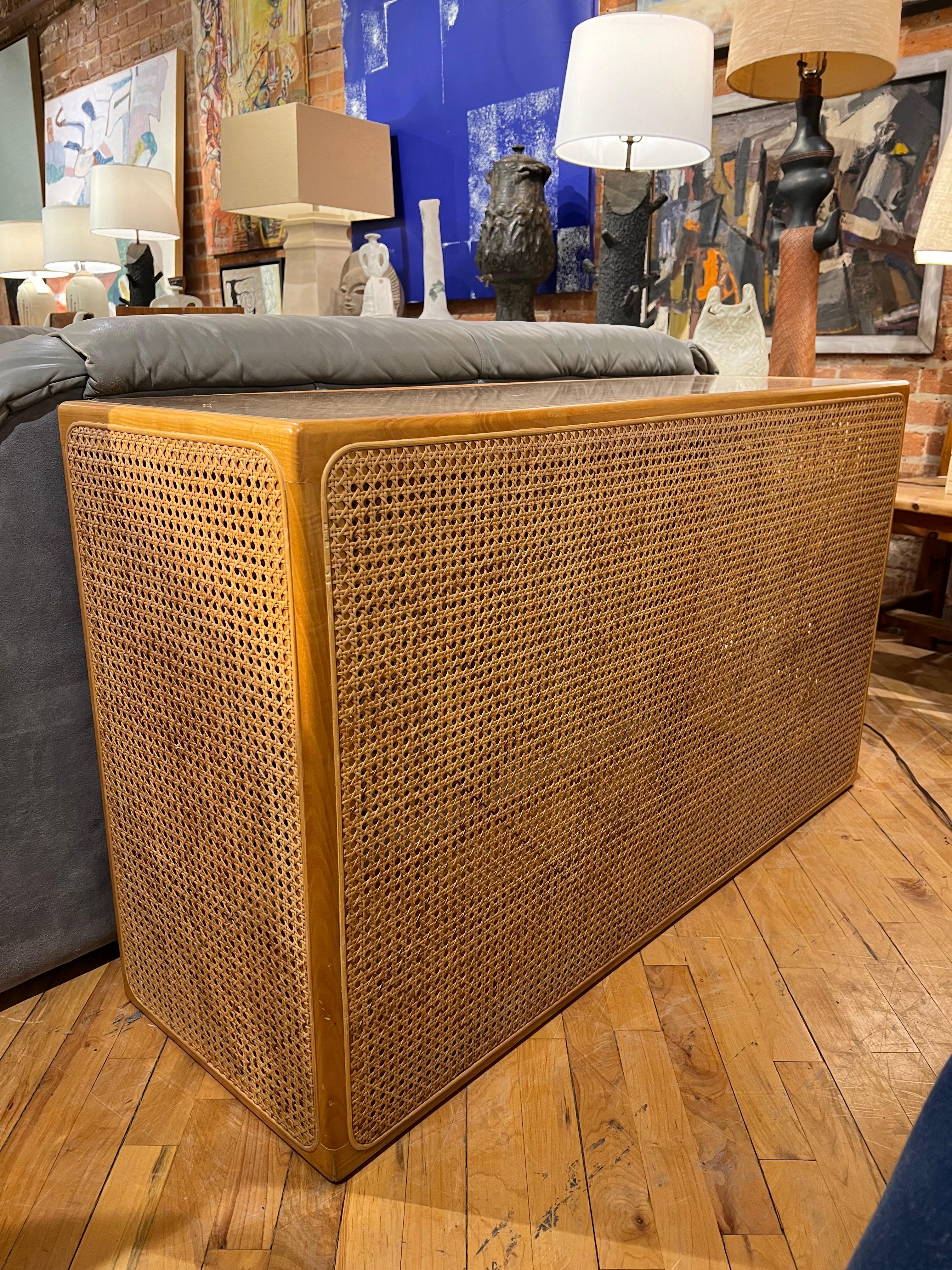 1970’s rattan console table finished on all four sides. Two console tables available 