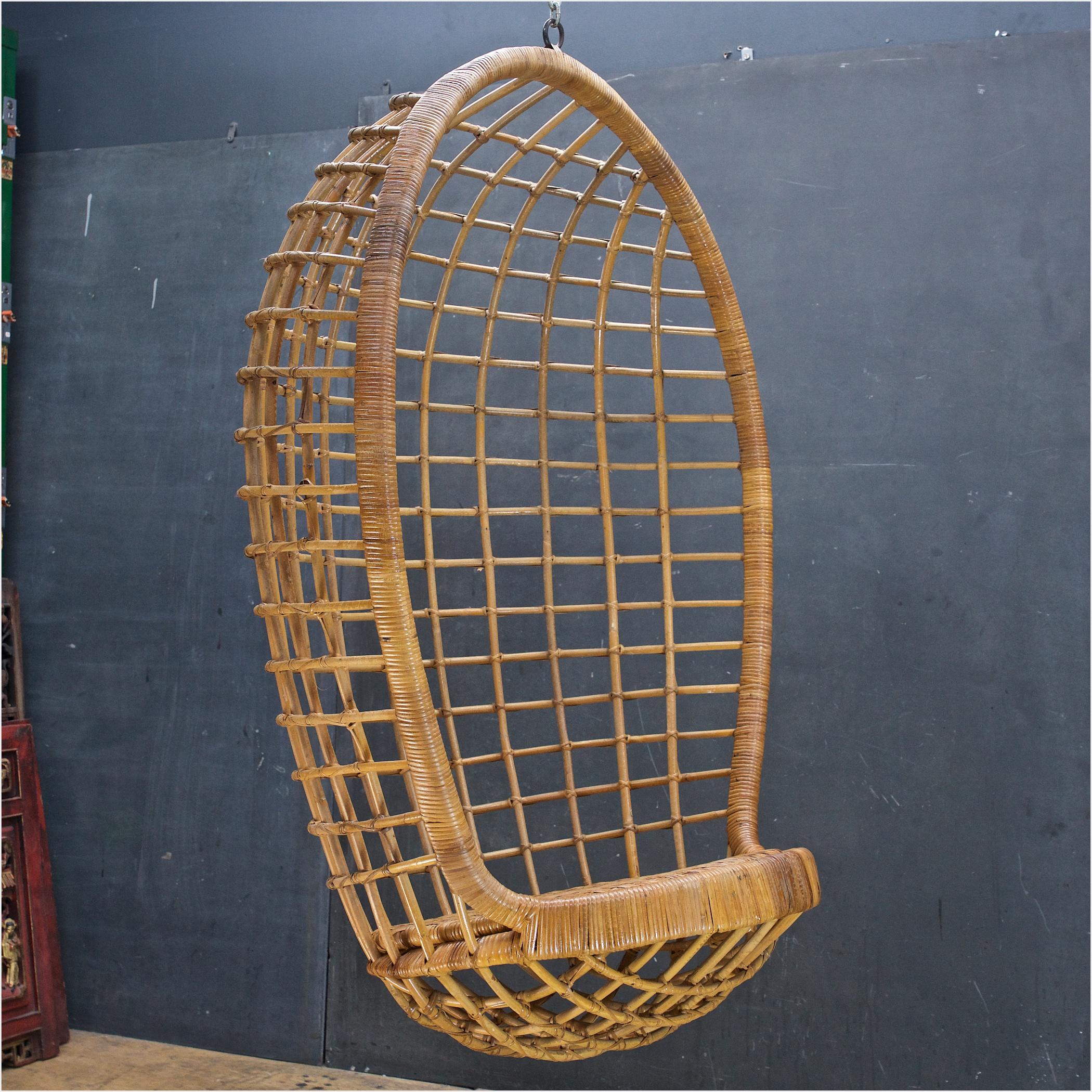 1970s Californian Design Rare Rattan Swinging Chair by Danny Ho Fong for Tropi-Cal.

A rare survivor, incredibly sculptural. It held my weight (160,) I gave it a test run. Quite comfortable. It is old wicker, so the more you plan on using it the
