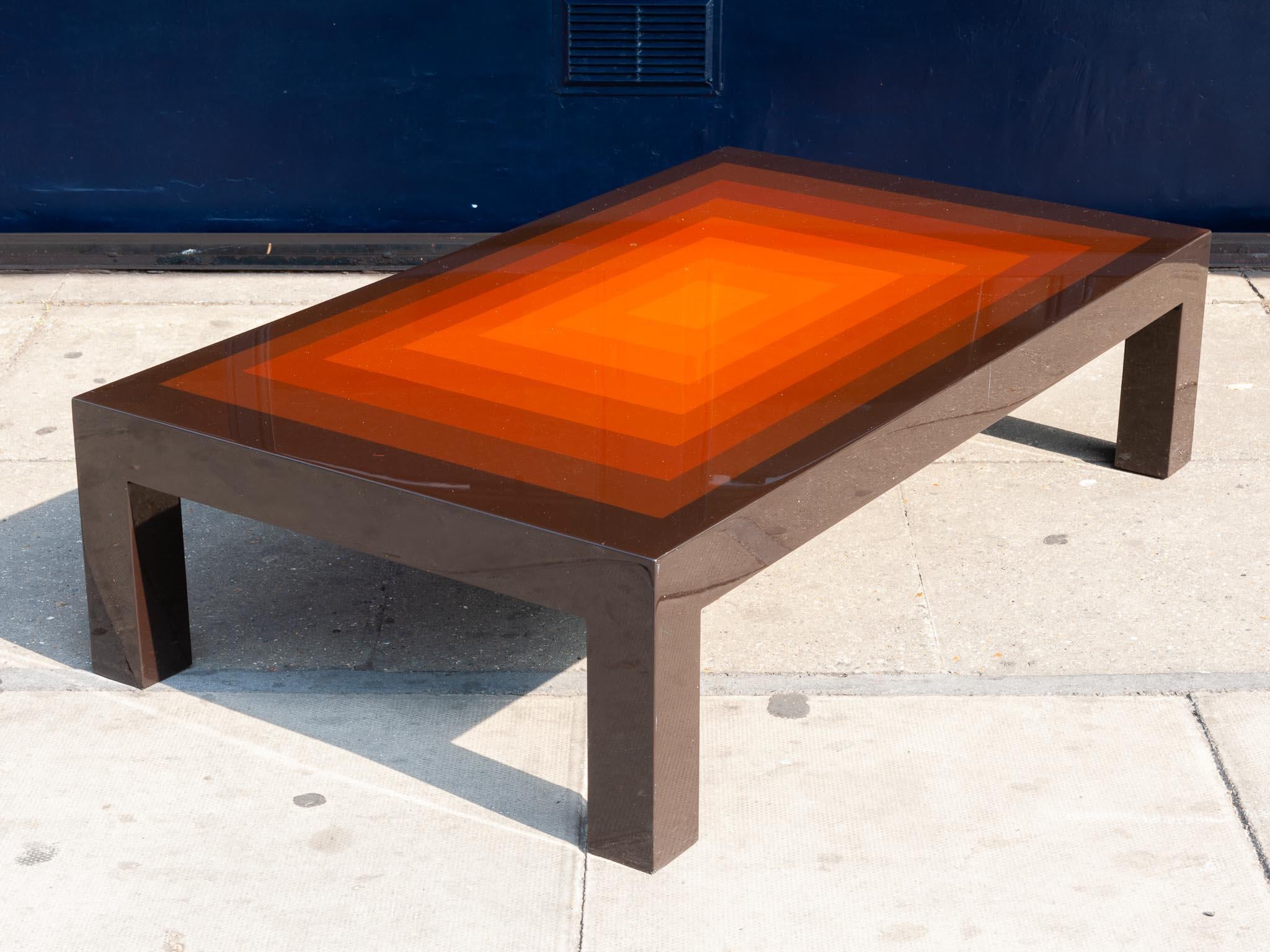 1970s rectangular multi-colored brown, red and orange high gloss low coffee table. An interesting coffee table with an added colorful wow factor of brightly colored rectangles increasing in brightness as they get smaller towards the centre. Some