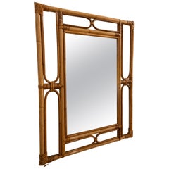 1970s Rectangular Rattan Mirror with a Geometric Frame in a Honey Tone.
