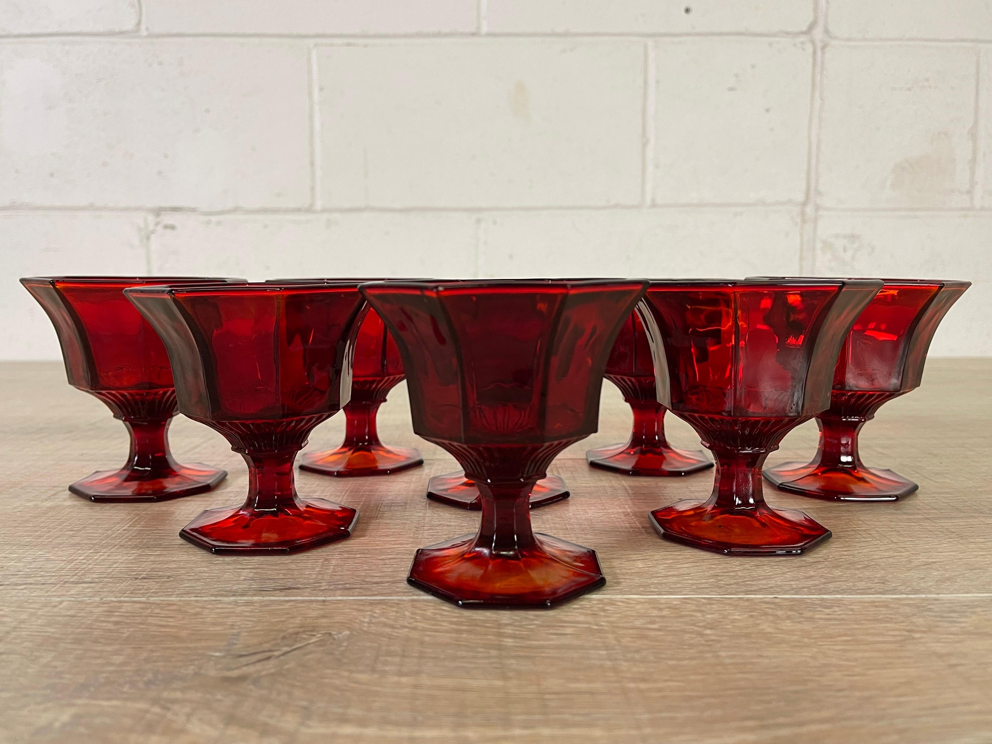 Vintage 1970s set of eight red glass coupes with 8 sides. No marks.