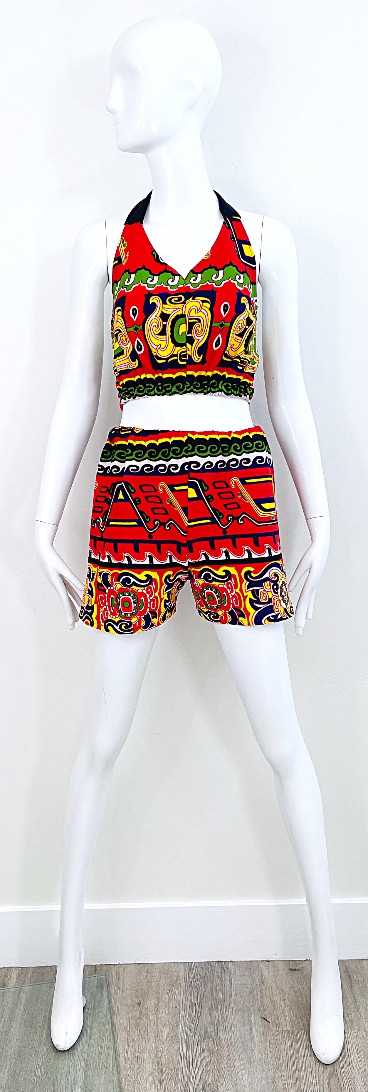 Amazing 1970s festive tribal abstract print knit crop halter top and hot pants / shorts ! Features vibrant colors of red, green, yellow, and navy blue throughout. Elastic waistband on the top and on the waistband of the shorts. Both pieces great