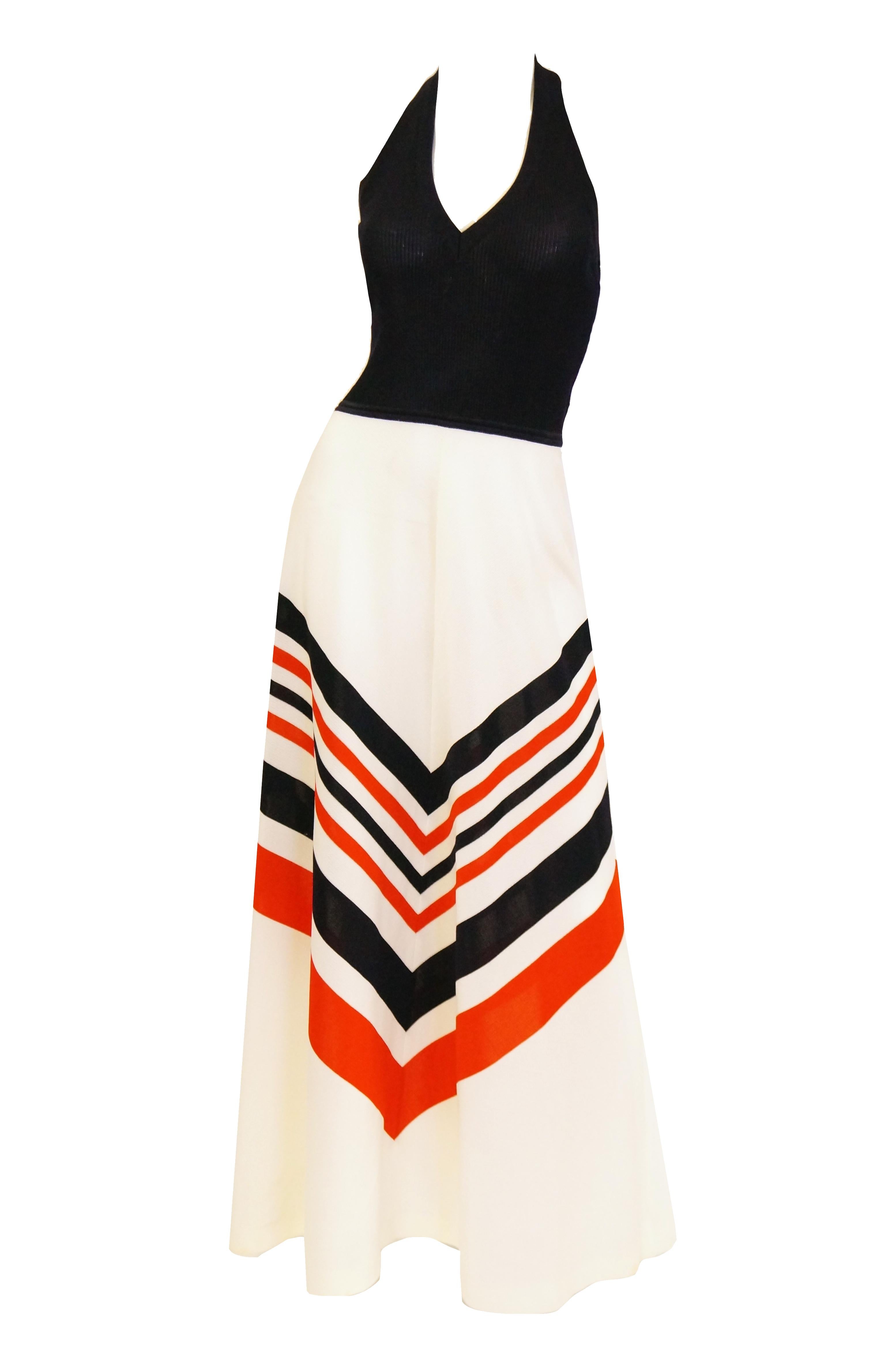 This playful yet elegant maxi length dress is simply fabulous! The dress has an A - line silhouette, with white skirt featuring red and blue chevron stripes, and a fitted rib knit top. The top has a deep  V - neck halter neckline, is sleeveless, and