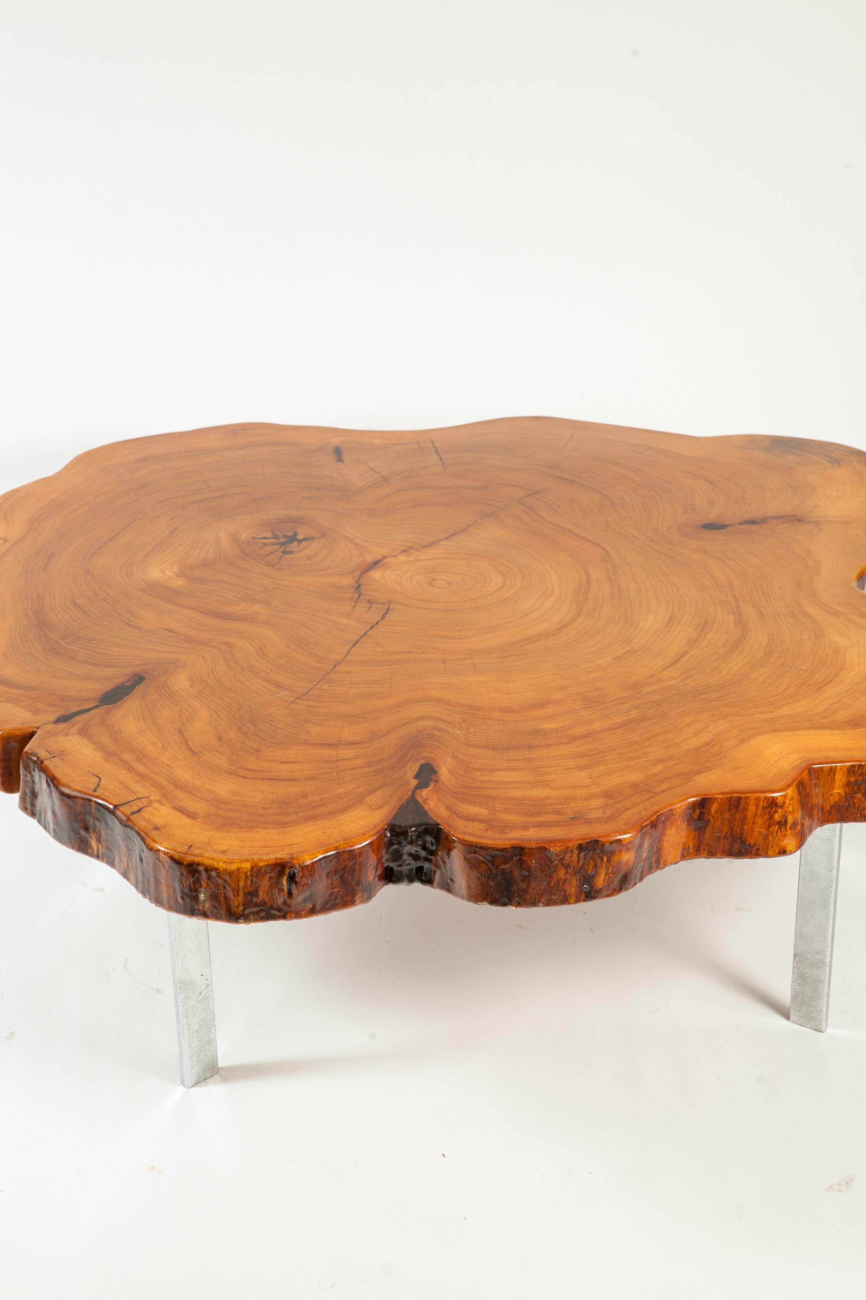Canadian redwood cross section coffee table on chrome base. Great condition and color with a nice weight.