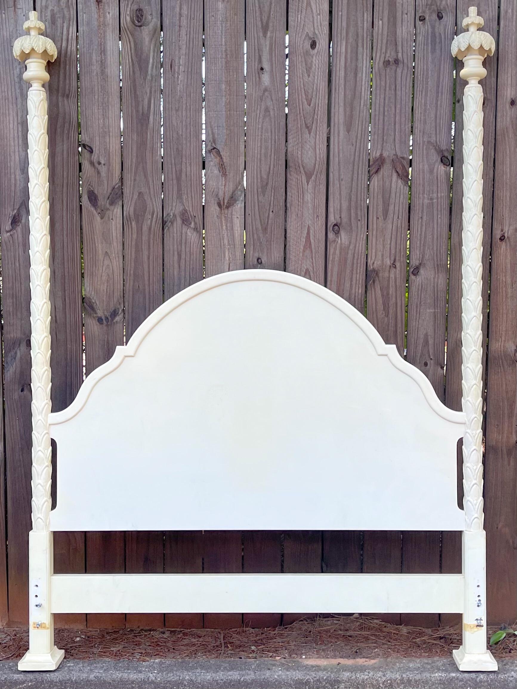 A personal favorite! This is a Regency Serge Roche style carved bed with palm frond finials. It is in the original finish which shows signs of wear such as fading. It was created by Roundtree. There are no side rails. It is a queen bed and an ivory