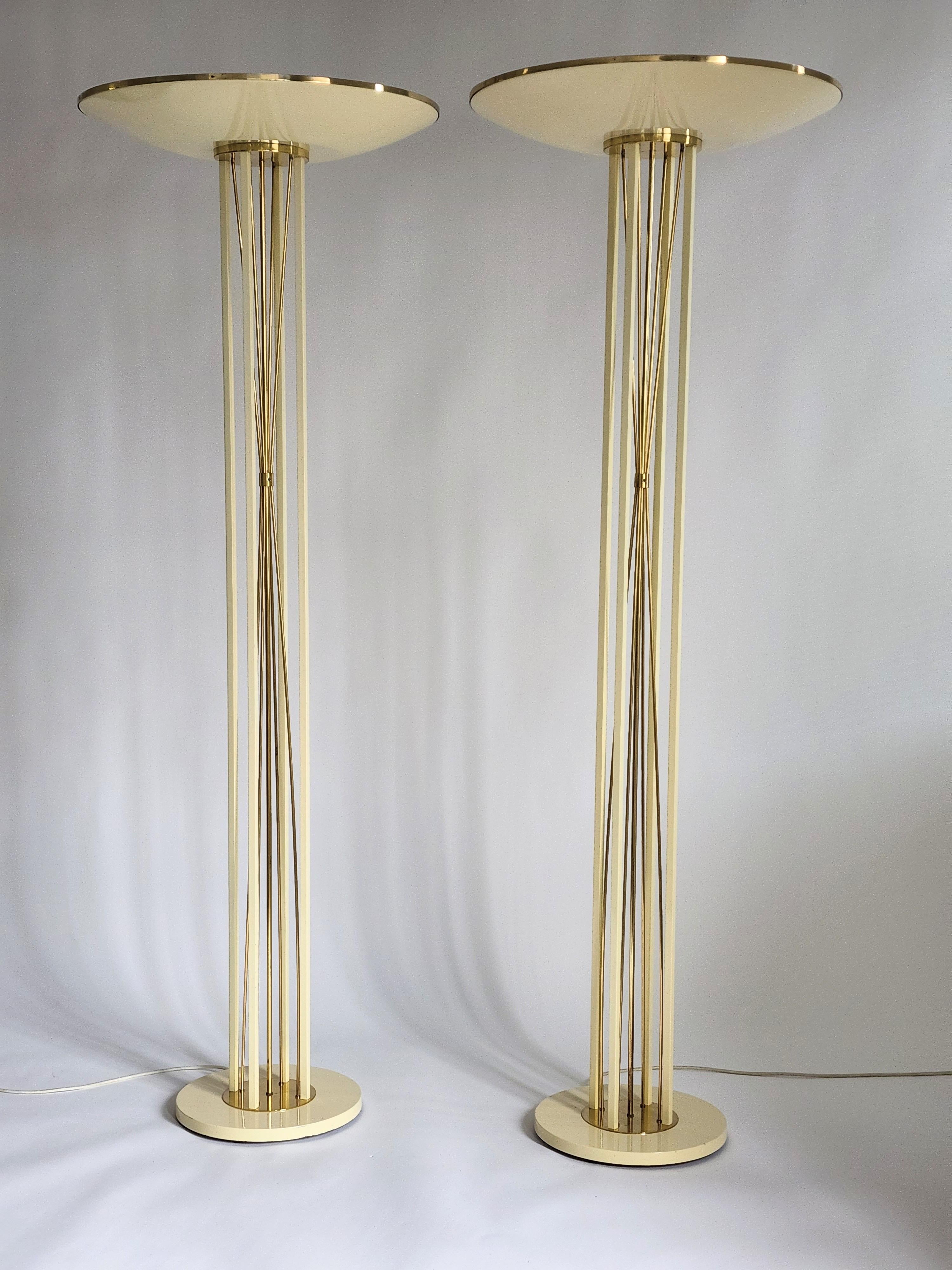 Minimalist Art Deco / neoclassical Reggiani torchiere. 

Enameled steel in a light butter cream tone with solid brass rods and trim.

Well made with prime quality material.

Measure 74.5 inches high. Shade is 26 inches wide. 

Weight 45