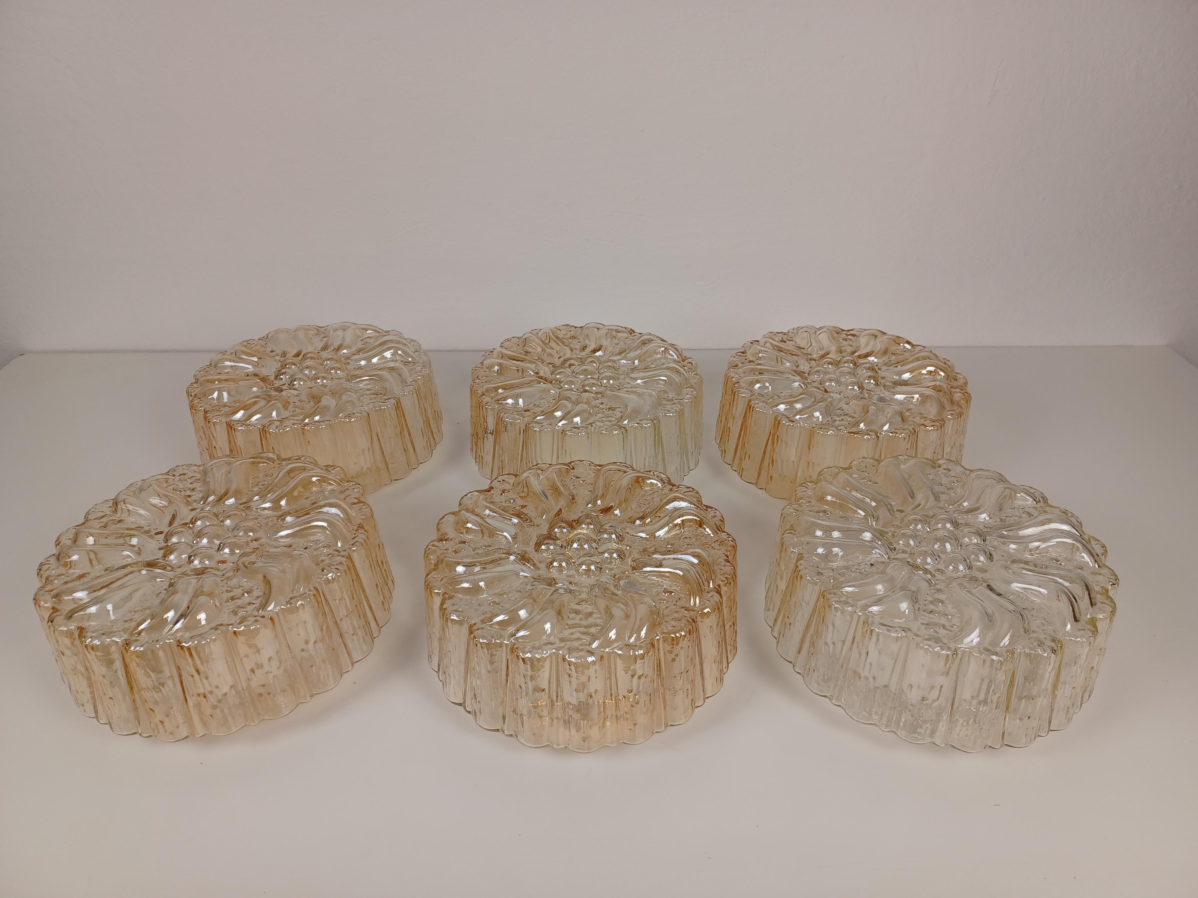 1970's Restored and rewired Danish flush mounts, wall scones in glass 

The flush mounts were manufactored by Knud Christensen Electric feature a completely rewired 1 light fixture  with a large thick glass lampshade with a structured surface.

The