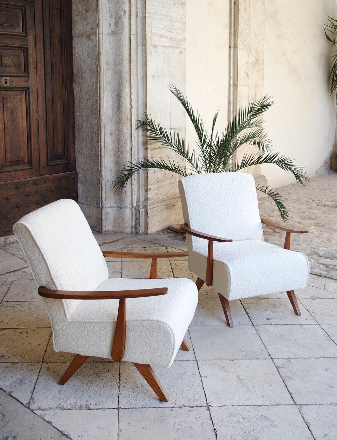A pair of 1970s armchairs with wooden frame, reupholstered in exceptional Dedar cream Boucle fabric. The chairs have been restored and reupholstered by Giorgio and Paolo here in Umbria using this exceptional Milanese fabric. Both chairs have