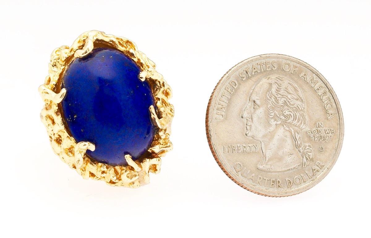 Stunning retro 1960's - 1970's 14 karat gold large and very blue Lapis Lazuli naturalistic free form cocktail ring.  The yellow gold open work organic style ring is set with a beautiful blue cabochon cut Lapis Lazuli, measuring 20x15mm on its own.