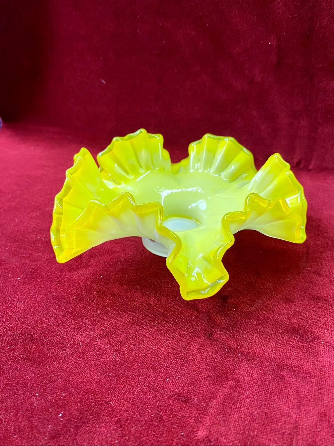 This is a retro 1970s opaline flared glass bowl that has a rare bright yellow top with a white bottom. It is in very good condition. A perfectly odd piece of decoration that will add a pop of color to your living area and can also be used