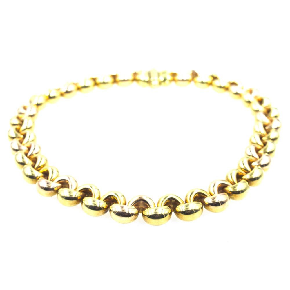 This fabulous solid link necklace is reversible. One side features a mix of 18 karat yellow and rose gold links, while the other side is crafted in all 18 karat yellow gold. The links measure .60 inches in width and the necklace measures 17.5 inches