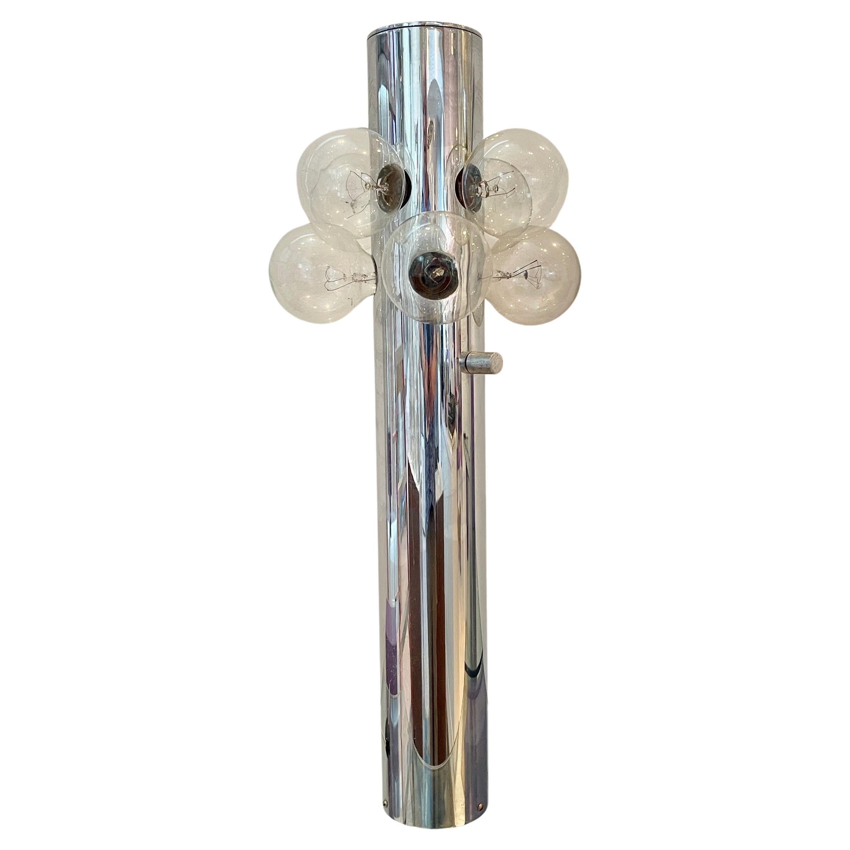 Space Age 1970’s mod vertical tubular chrome table lamp with eight Edison screw lightbulbs. Shown with half-chrome and clear round glass globe bulbs but also looks glamorous with other bulbs. Sonneman label below cord exit.