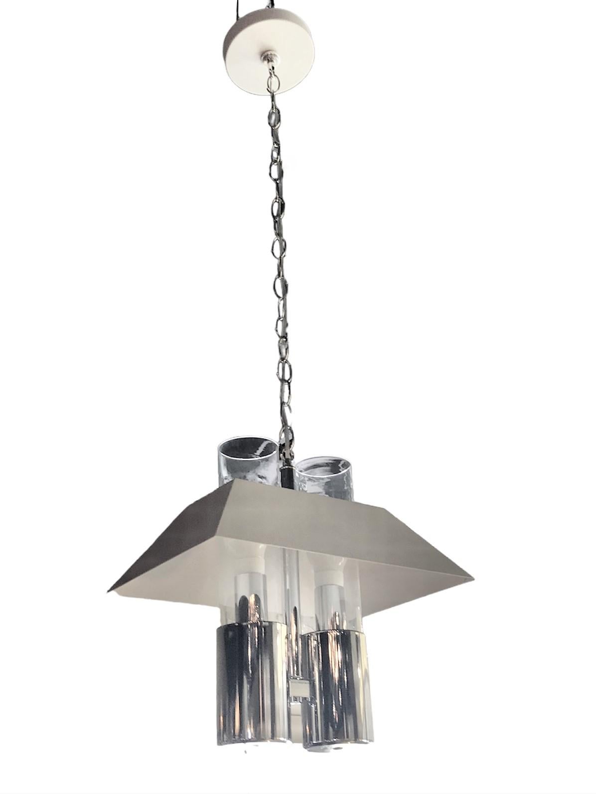 Attributed to Robert Sonneman, a fantastic pendant fixture in a Modern Bouillotte style. A chrome base supports two cylindrical glass shades that protude through a white metal shade. Having a solid metal shade, the light diffuses down and shines up