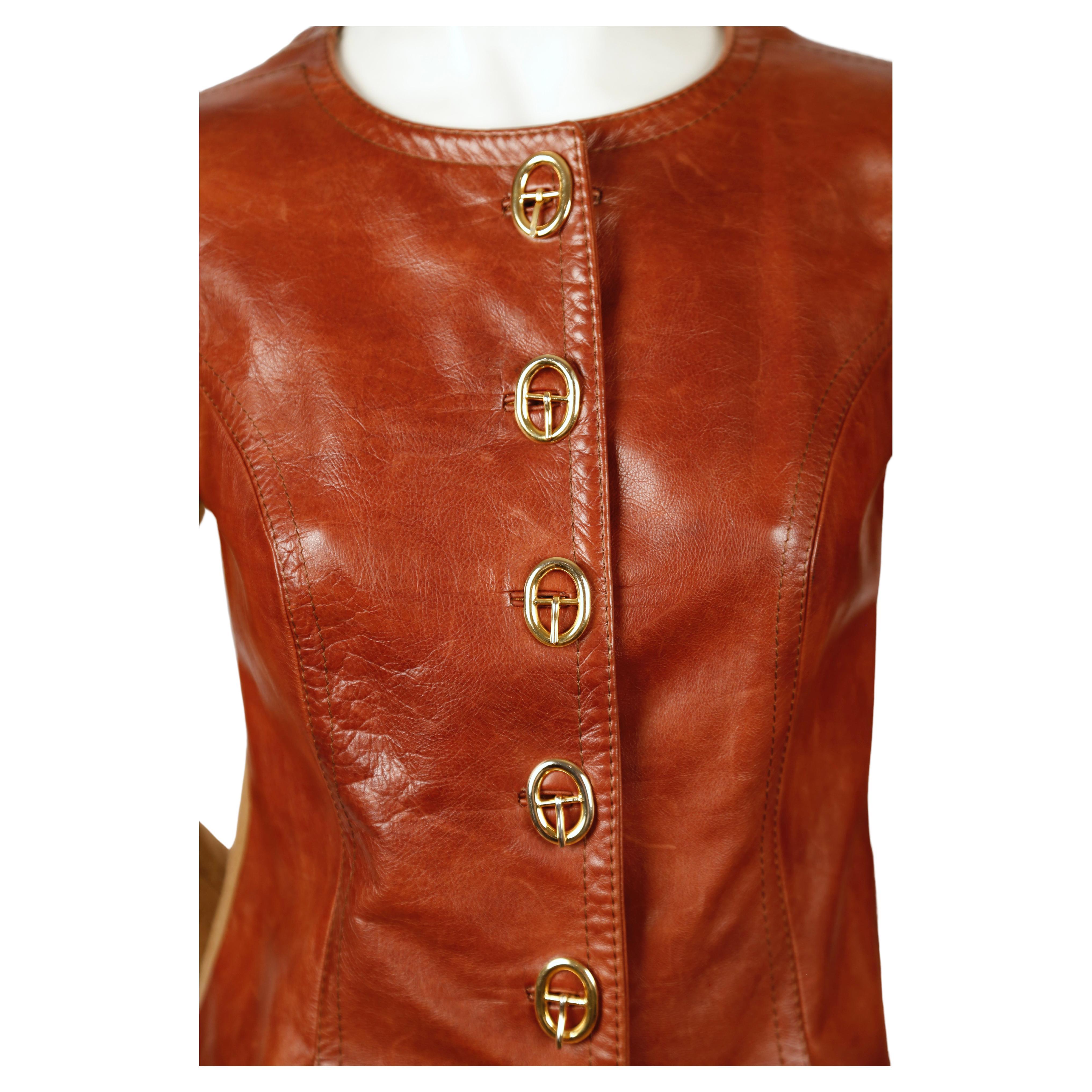 Very unusual sweater jacket with leather front and gold toned 'buckle' button closure designed by Roberta Di Camerino dating to the 1970's. Best fist a US 2-6. Approximate measurements (unstretched): shoulder 13
