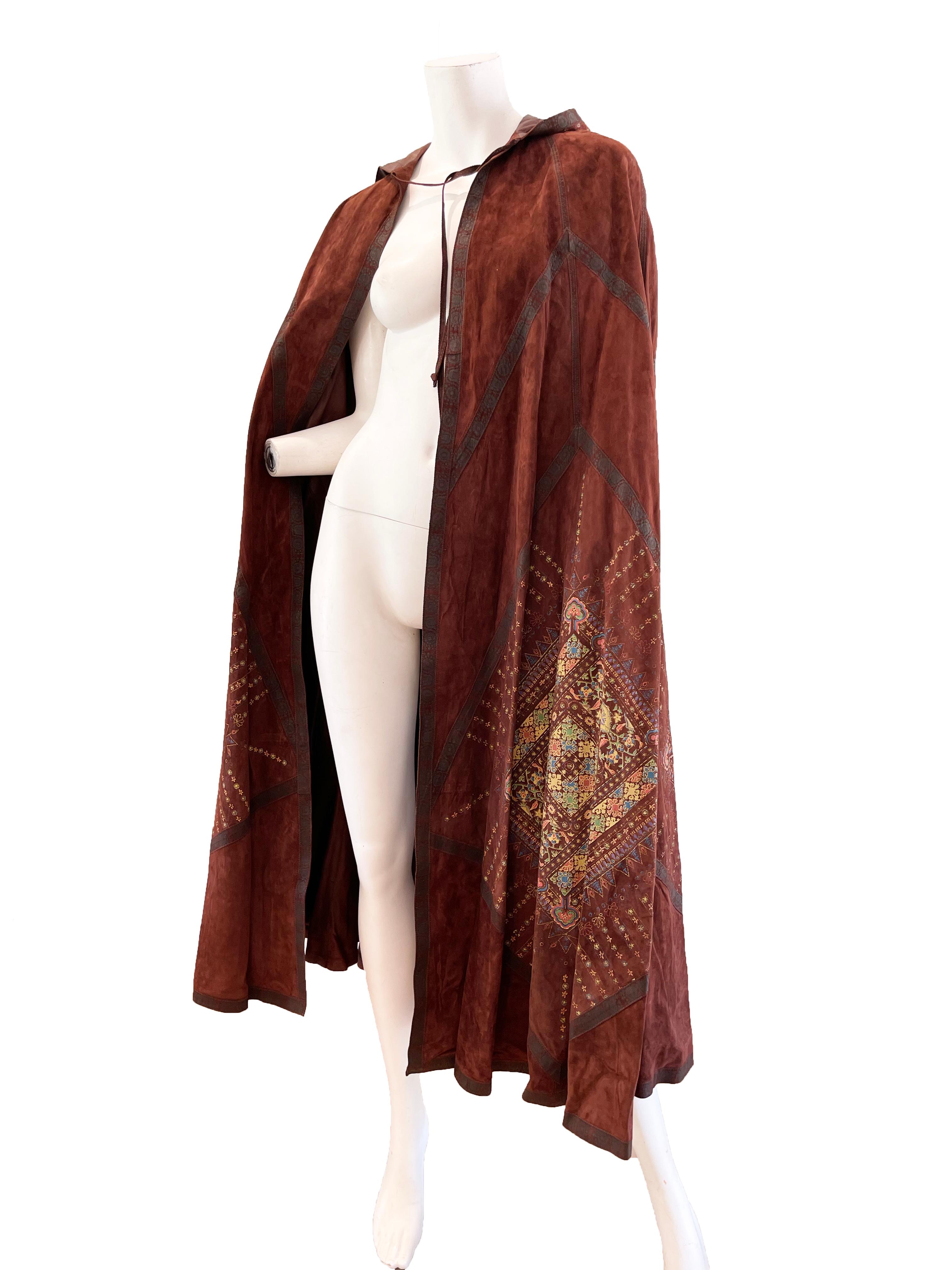 1970s Roberto Cavalli brown suede cape.

Tassel hood
Tie closure at neck
Condition: good, some all over wear
One size