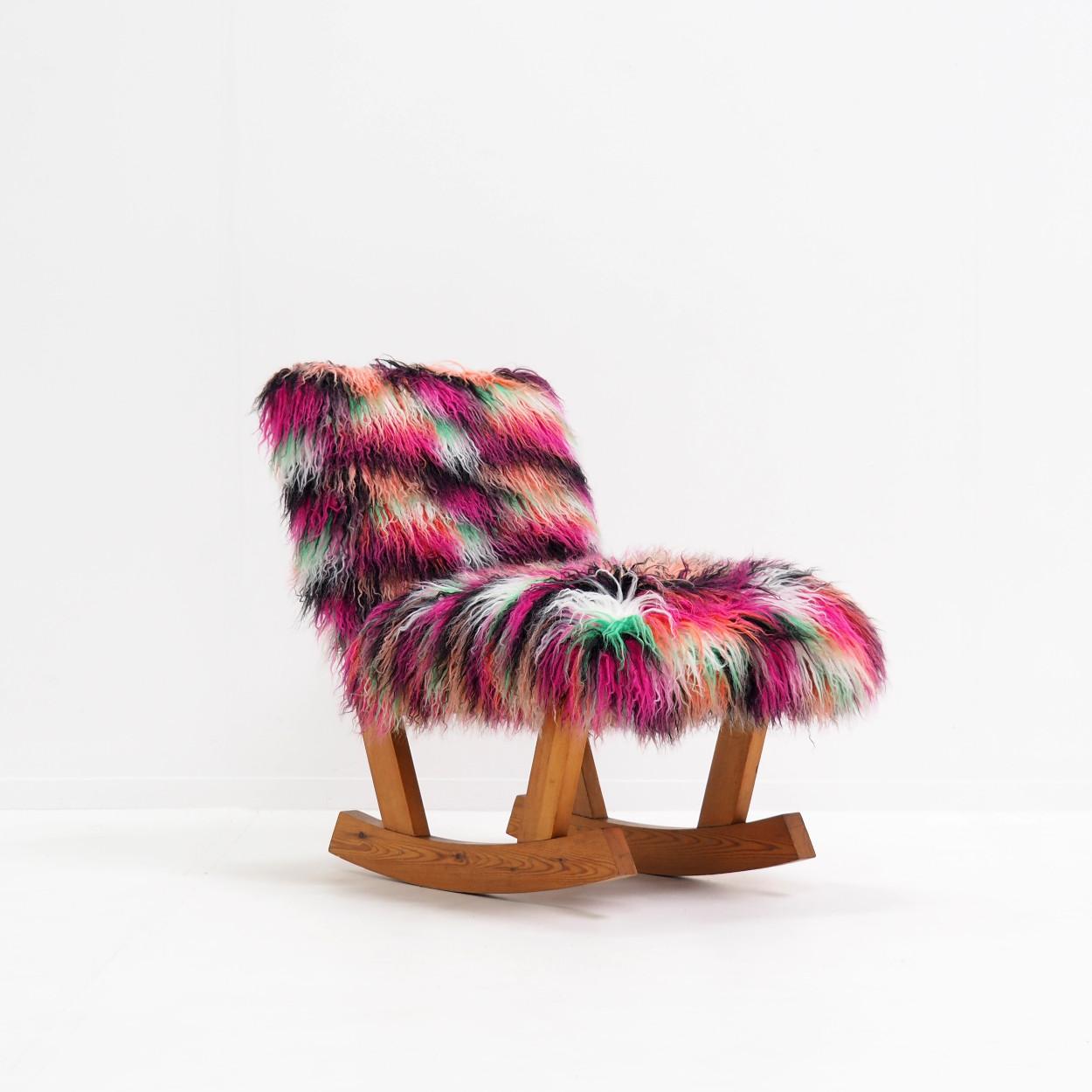 Very charming and cheerful rocking chair, reupholstered in a fabric used or designed (I'm not exactly sure, but one of the two) by the Belgian fashion designer Dries Van Noten. Very decorative.

The rocker itself dates from the 1970s and is made of