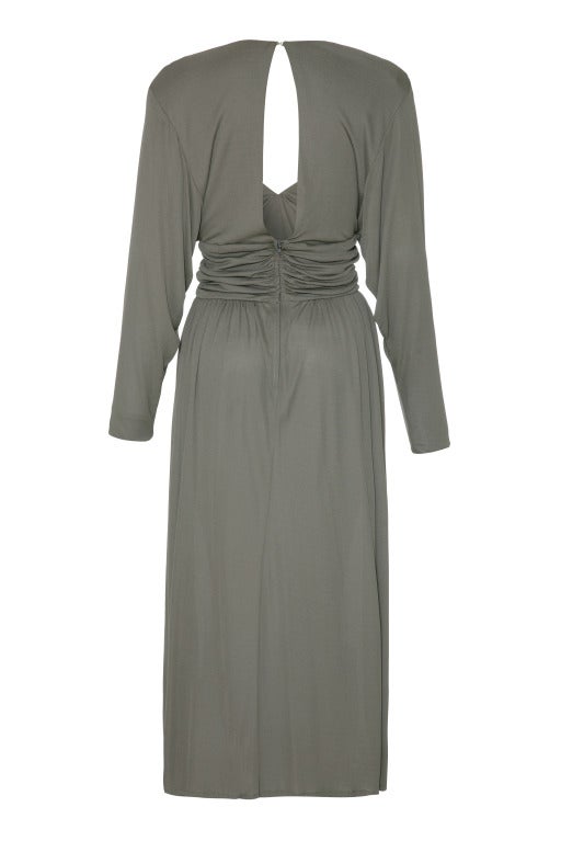 This desirable 1970s light grey silky jersey 'studio 54' dress by Roland Klein is simultaneously seductive and sophisticated.  Featuring batwing cut sleeves and a plunging V-neck line the dress is gathered under the bust, at the top of the skirt and