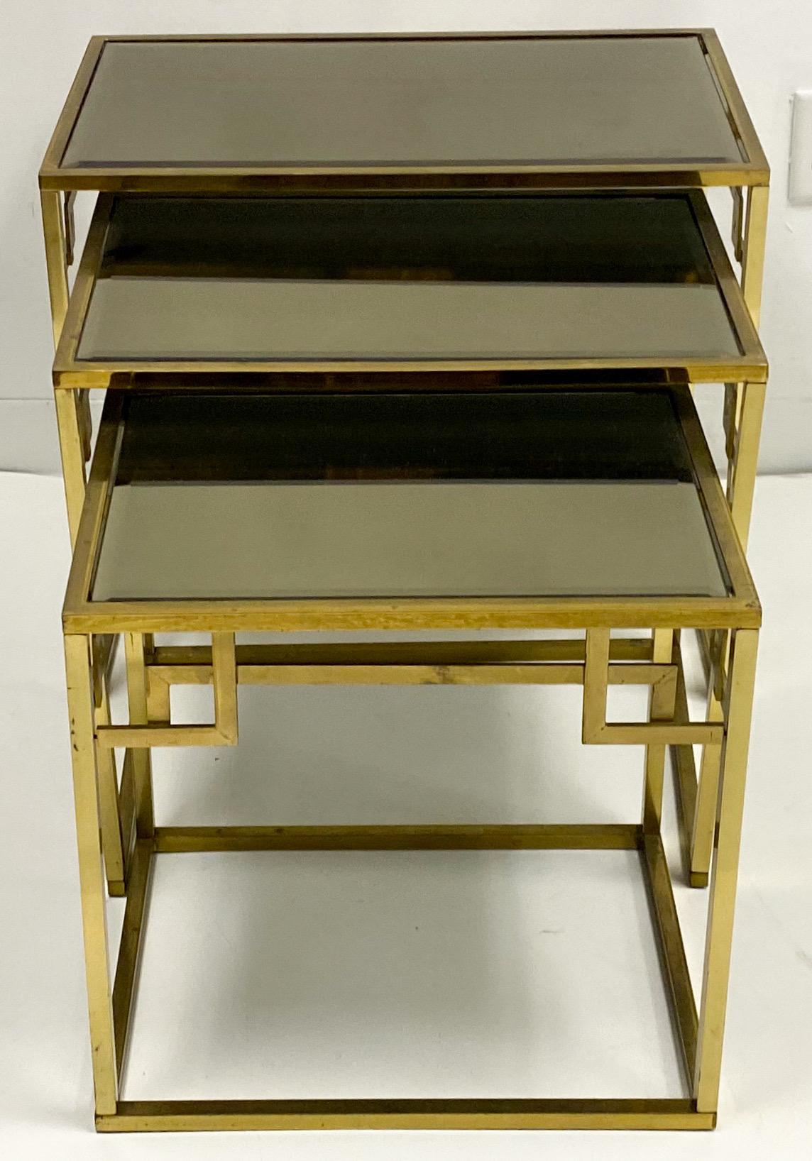 This is a set of Italian neoclassical style solid brass Greek key nesting tables. The tops are mirrored. They date to the 1970s and are in very good condition.