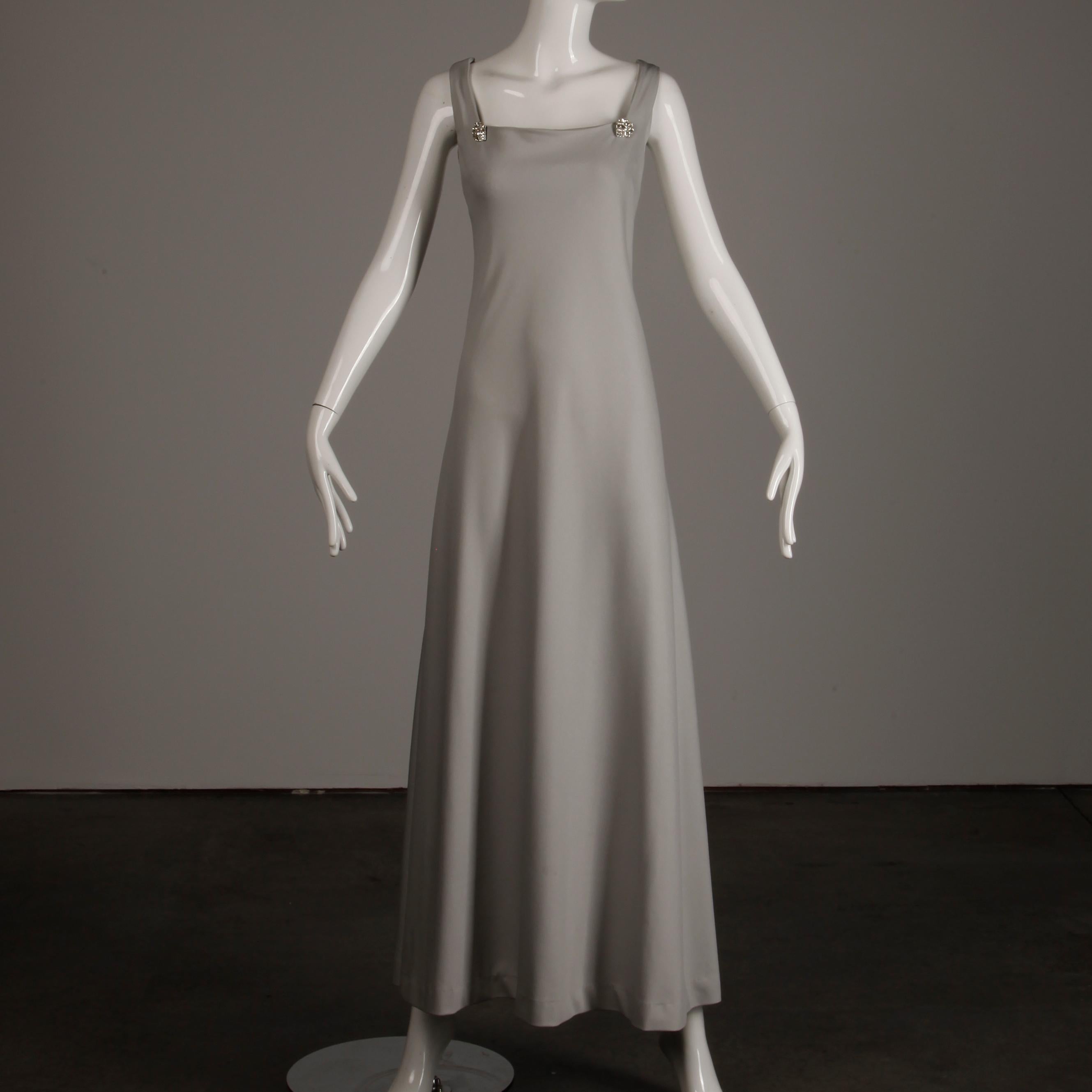 Unlined with rear zip and hook closure and hook closure affixing rhinestones from the dress to the cape. The marked size is 12, and the ensemble fits like a modern medium-large. The bust measures 41