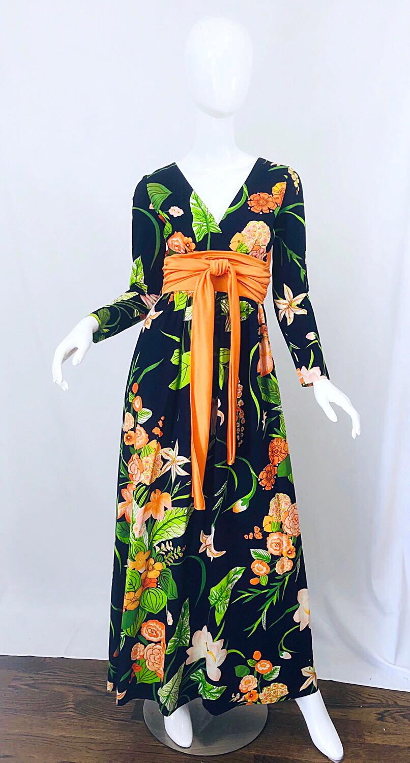Amazing 1970s RONALD KOLODZIE navy blue, orange and green long sleeve jersey maxi dress! Features a tropical Hawaiian print in vibrant colors of neon orange, green, peach and light pink throughout on a navy blue background. Attached obi sash detail