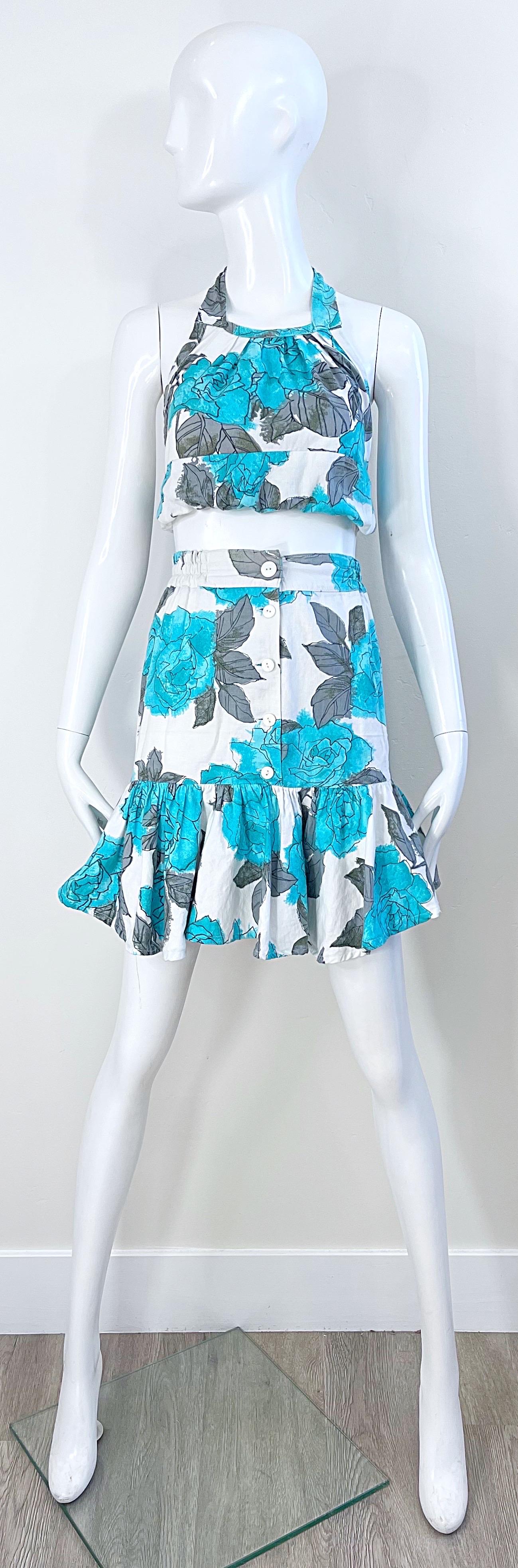 Amazing vintage 1970s turquoise blue, gray and white cotton crop top and skirt ensemble ! Crop top features elastic in the back and ties at top back center neck. Skirt has elastic at the side of each waistband, and buttons up the front. 
Both pieces