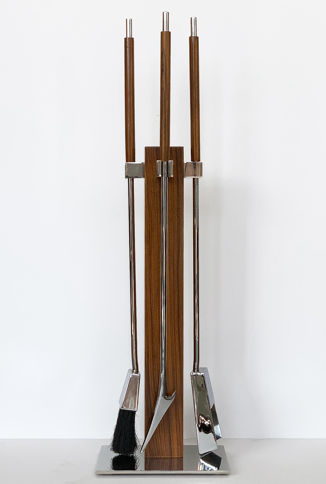 Rosewood and chrome fireplace tool set attributed to Danny Alessandro / Albrizzi, circa 1970s. Set includes the poker, shovel, broom and Stand. A rectangular chrome plate supports a 3.25