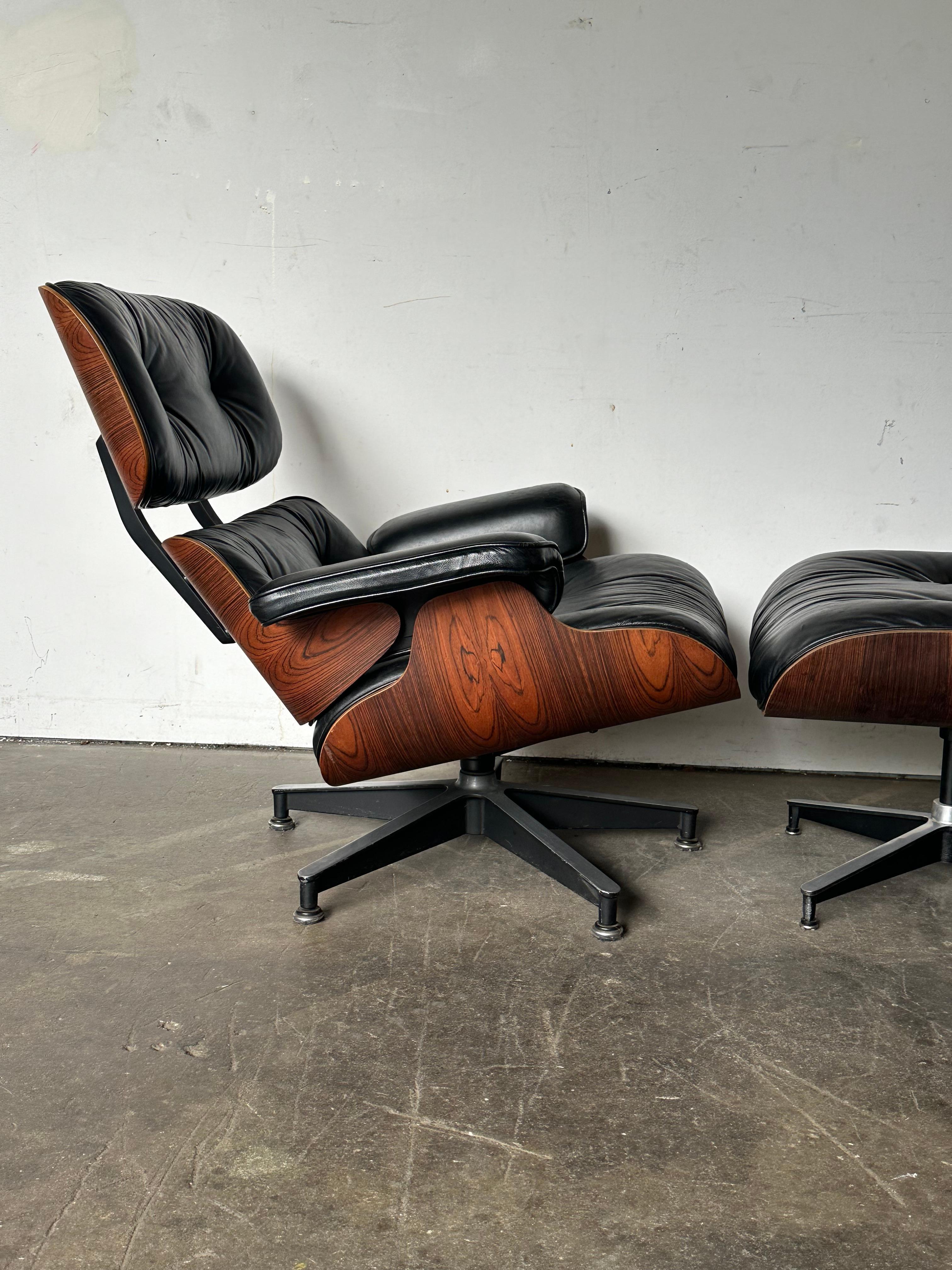 Gorgeous edition of the iconic Eames Lounge Chair and Ottoman. Circa 1970s production executed in black leather and lustrous Brazilian rosewood (no longer used because of environmental protections, but most coveted by collectors and design