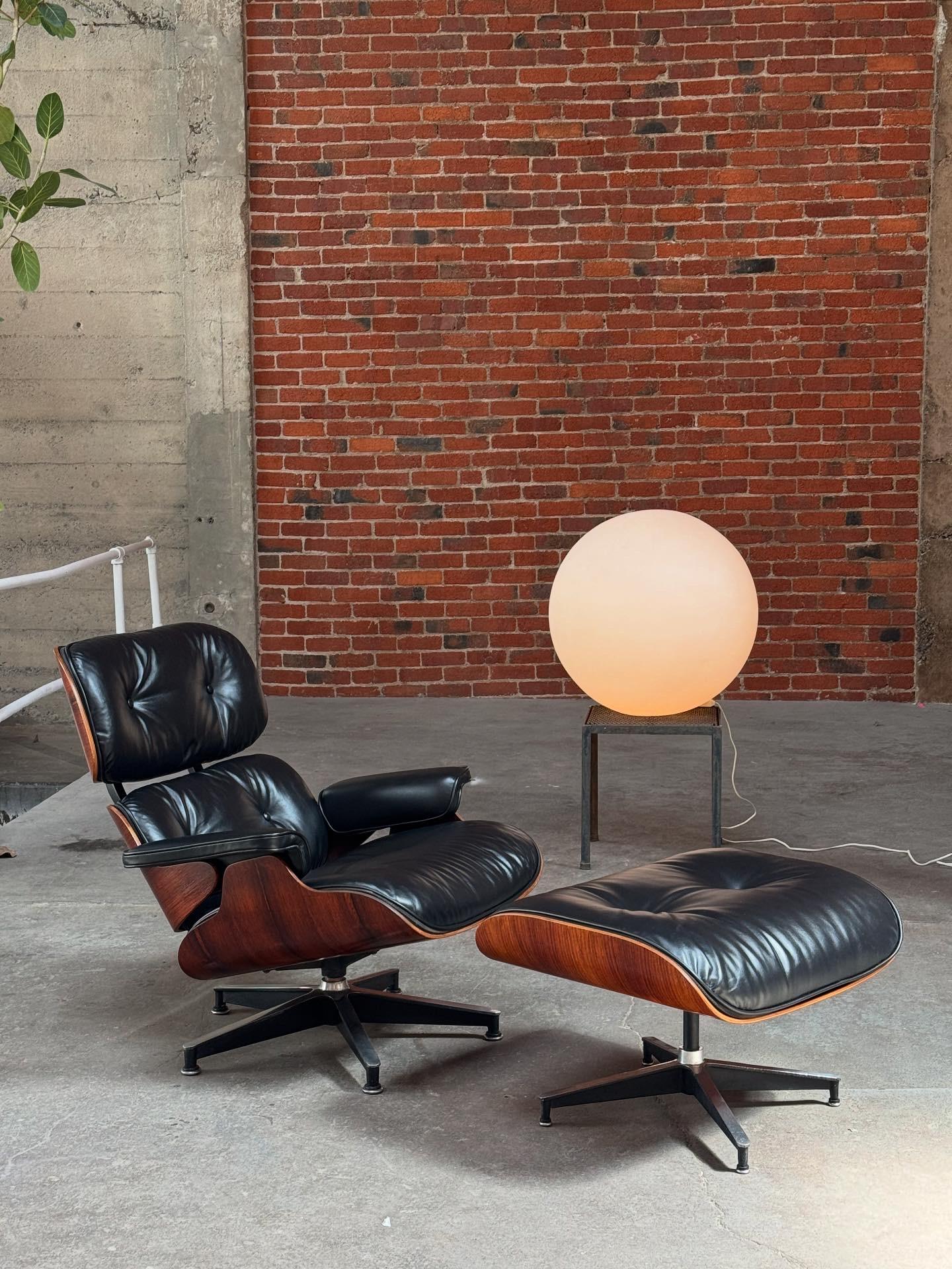1970s production Eames lounge and ottoman, crafted of Brazilian rosewood and reupholstered in premium butter soft leather imported from Austria. The rosewood outer shells were refinished using a process in which they are gently hand sanded and over
