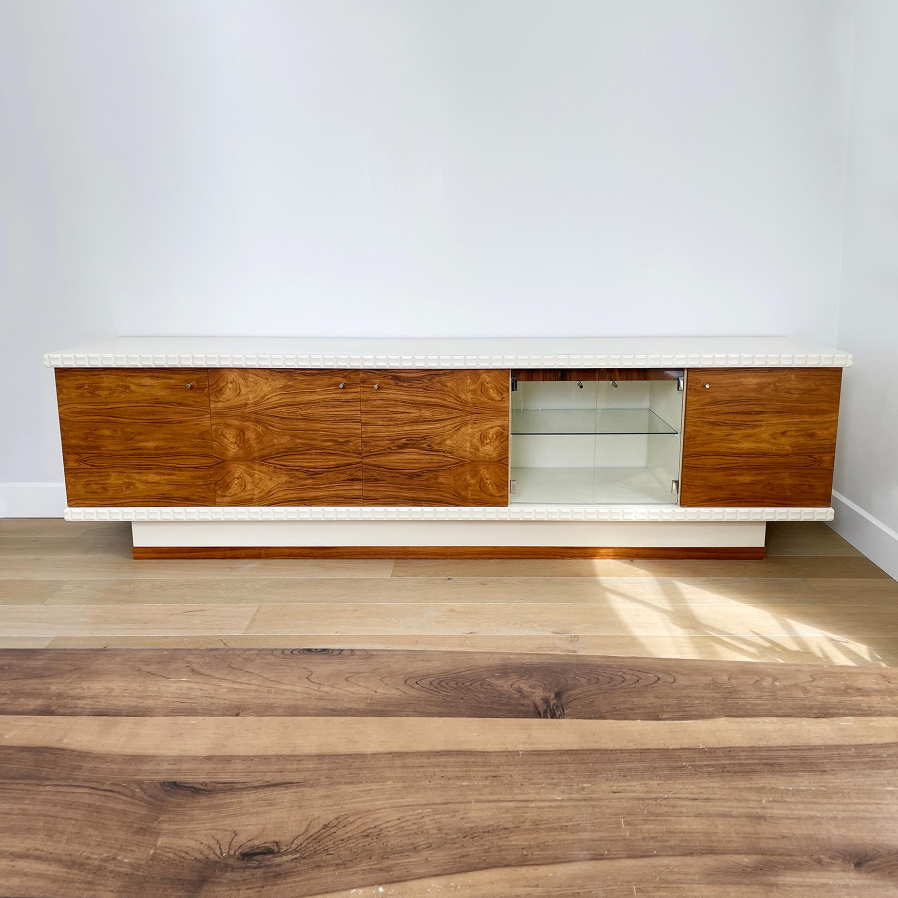 An impressive West German sideboard with a white powder-coated frame and Brazilian rosewood or Rio Palisander veneered doors and accents, which accommodates a small drinks serving station. This long sideboard sits on a pedestal, with the rosewood