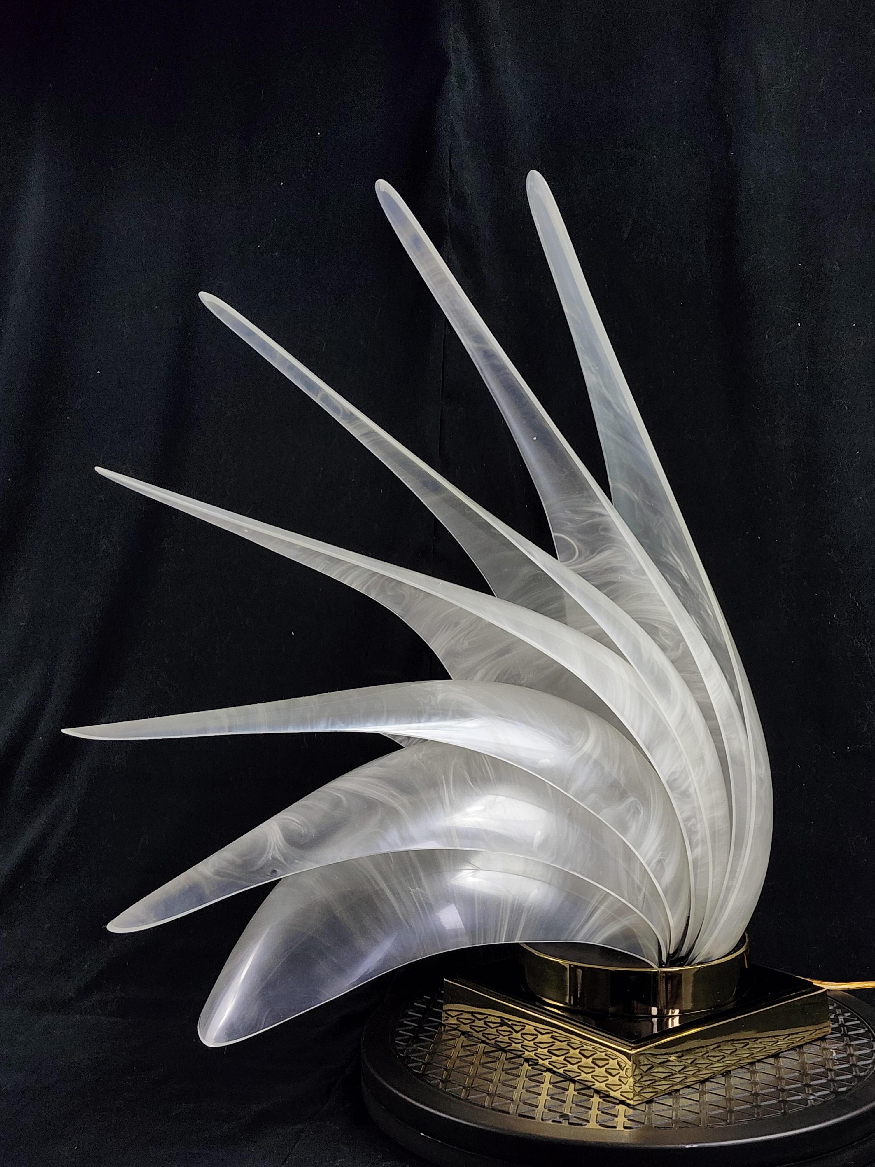 Iconic 'Bird of Paradise' table lamp from Roger Rougier, Canada. 

Elegant sculptural fan of pearl finish acrylic shell sitting on a thick brass base . 

Contain one E26 ceramic socket rated at 40 watt. 

.