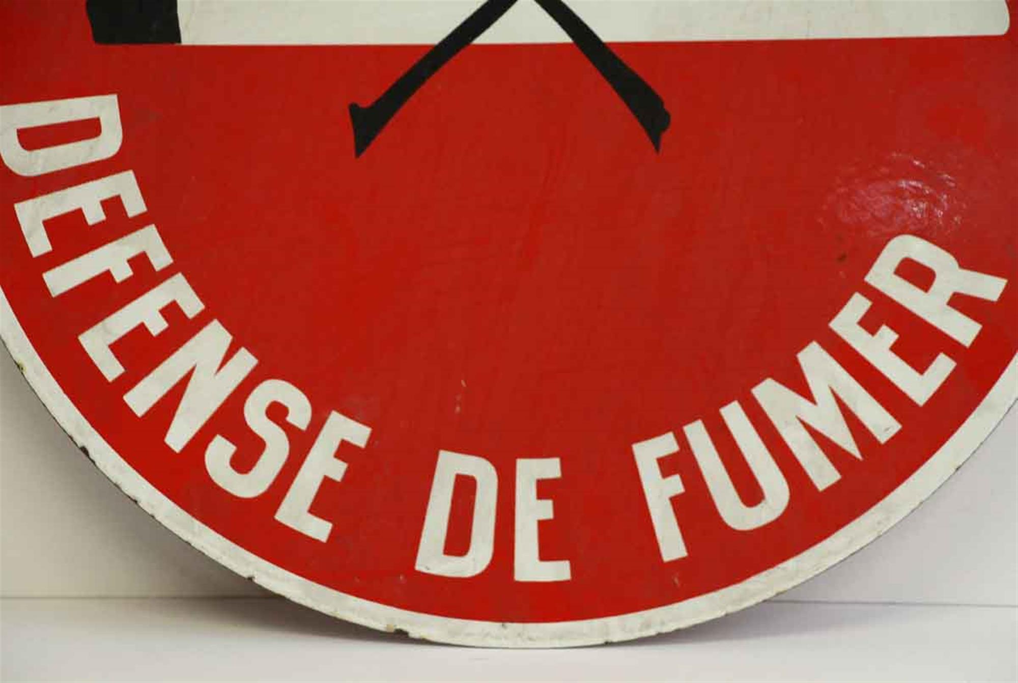 1970s round red Defense de Fumer no smoking double sided French sign with white lettering. This can be seen at our 400 Gilligan St location in Scranton, PA.
