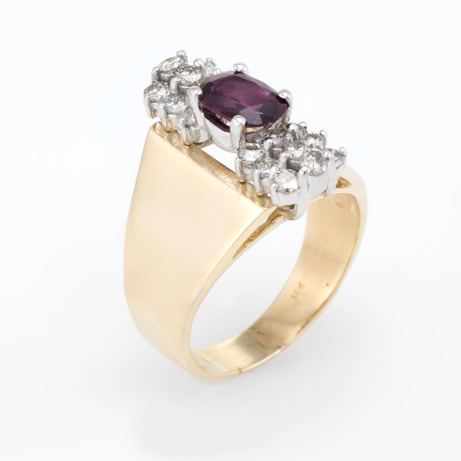Elegant vintage cocktail ring (circa 1970s), crafted in 14 karat yellow gold. 

Faceted oval cut ruby measures 7.5mm x 5mm (estimated at 0.80 carats), accented with 18 x .04 estimated round brilliant cut diamonds. The total diamond weight is