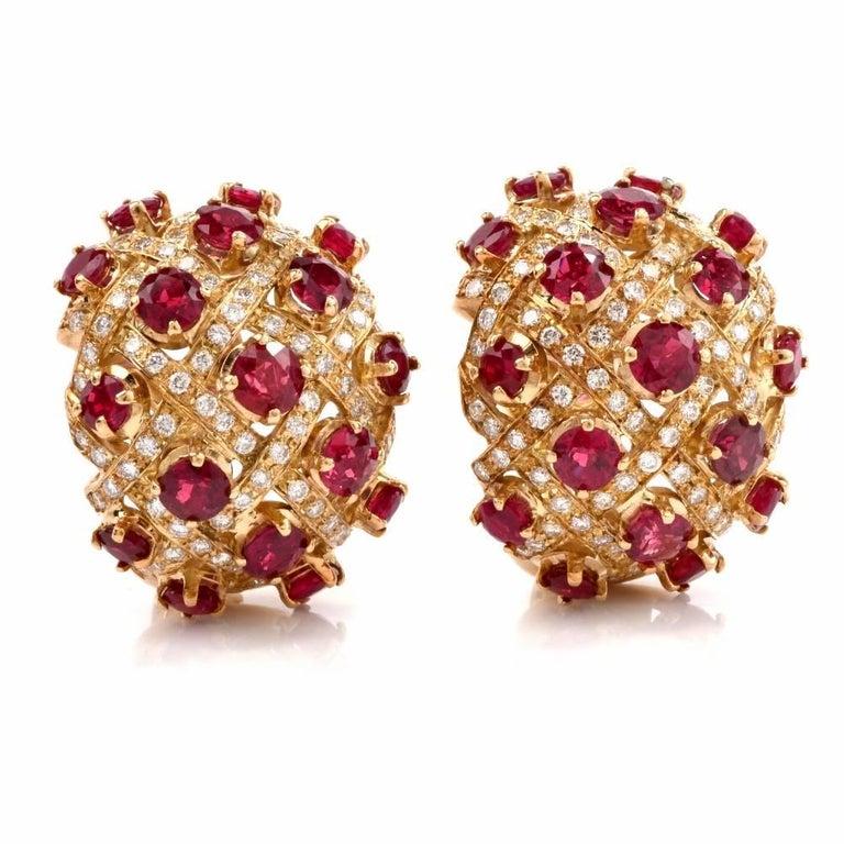 These clip-on earrings with rubies and diamonds are crafted in solid 18-karat yellow gold, weighing 31.2 grams , and measuring 25 mm long x 23 mm wide. Designed as vividly colored, convex plaques, the earrings are adorned with a total number of 34