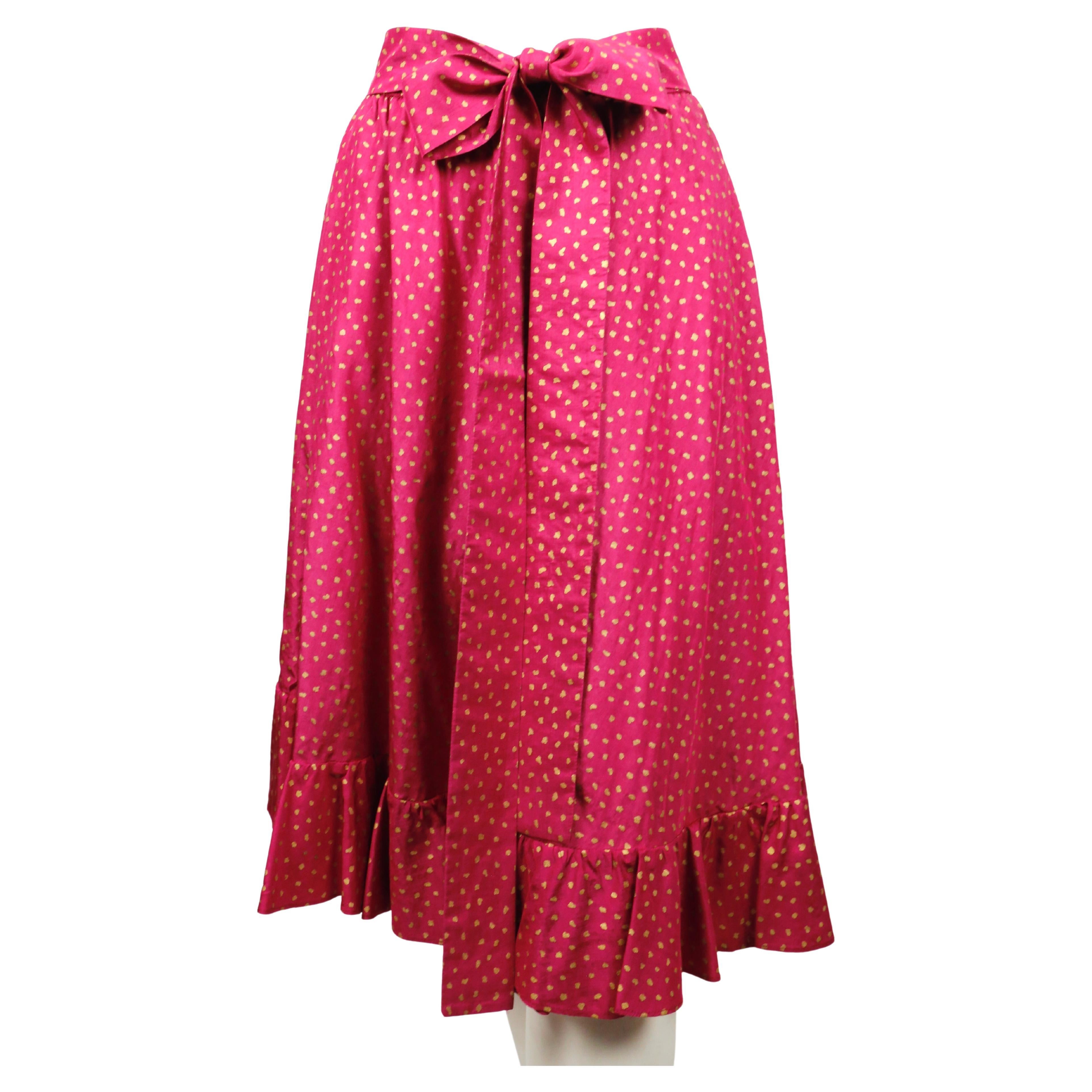  Fuchsia and gold silk skirt with ruffled hem and long belt designed by Yves Saint Laurent dating to the late 1970's. French size 36 however this also easily fit a French 38 or 40. Approximate measurements: waist (unstretched) 23